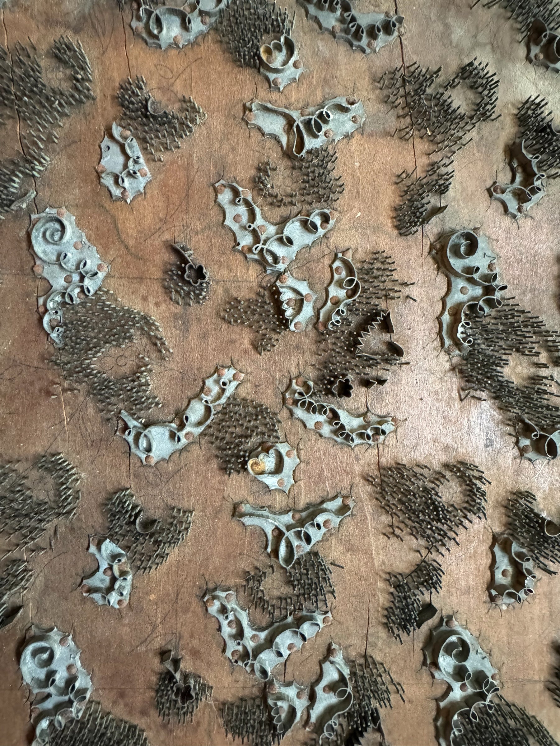 A vintage carved wooden printing block with intricate, repeating patterns, engraved with an unknown artist's signature and stamped "Made in France." The wood shows signs of age and wear, adding to its historical character