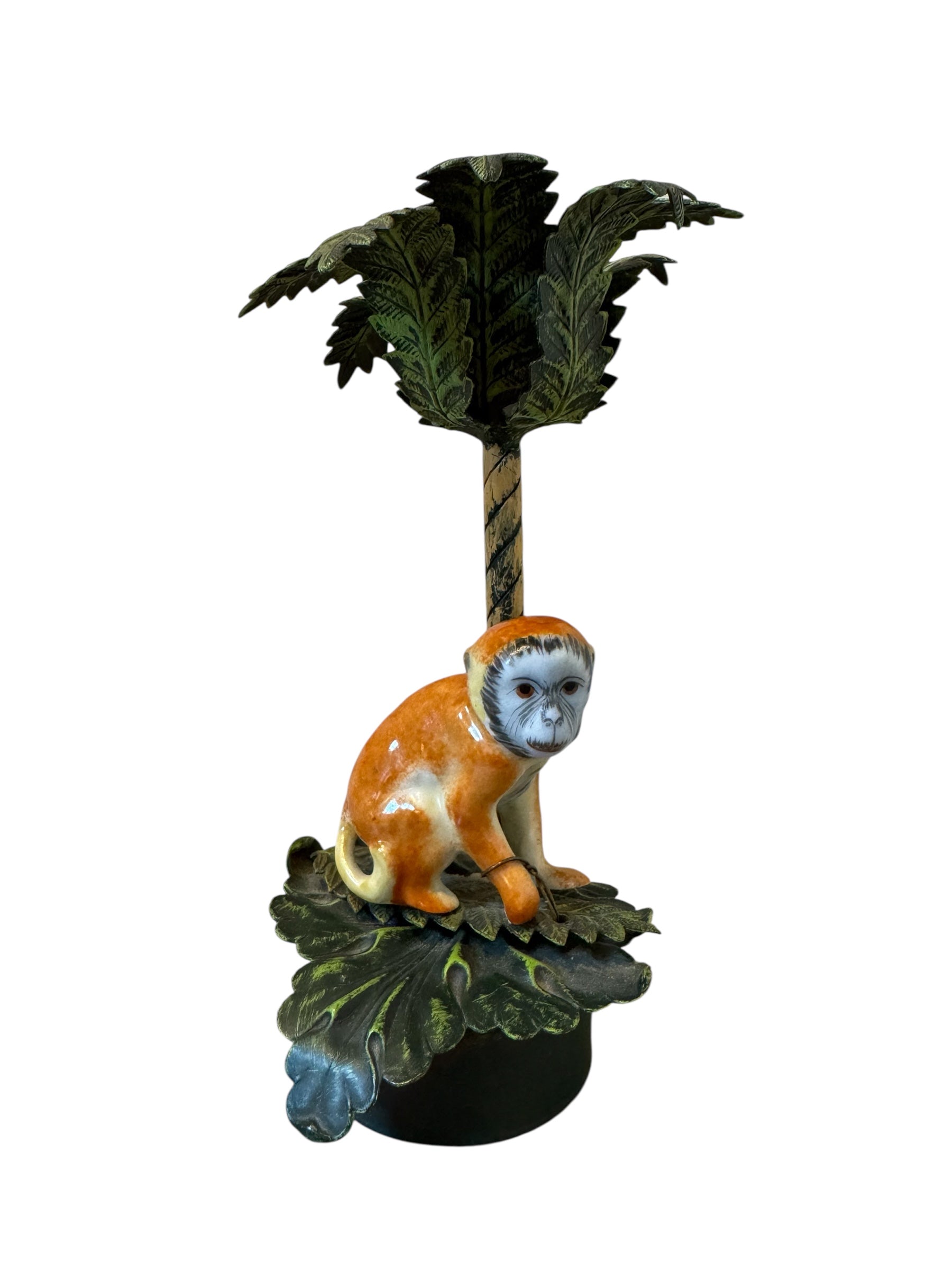 Decorative figurine of a monkey on a branch with a palm tree against a white background