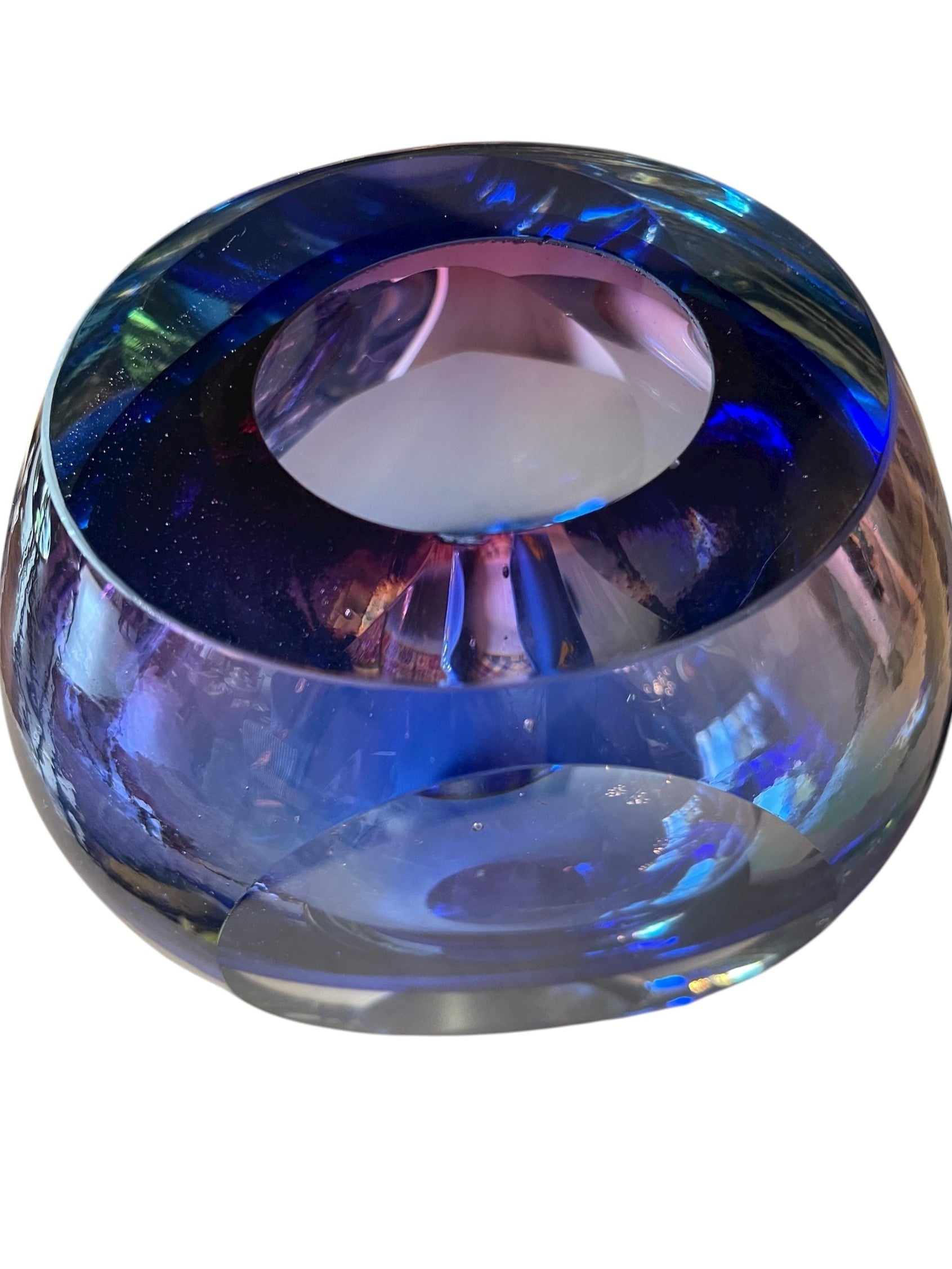 Sommerso glass vase with flattened sides creating a fish-eye effect, featuring cobalt and indigo colors and internal bubbles.