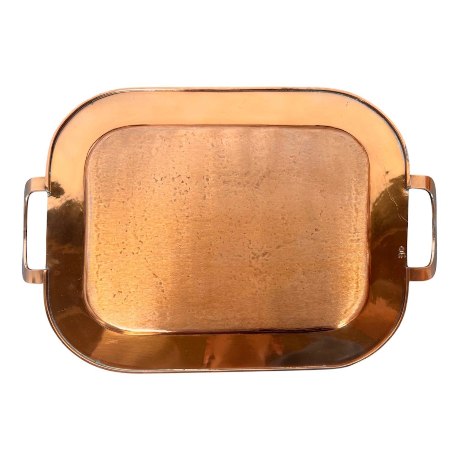 The set includes a large, rectangular, hammered copper tray with geometric openwork handles. Resting on the tray is a tall, slightly tapered copper coffee pot with a wooden handle, a matching smaller creamer pitcher with a similar wooden handle, a lidded sugar bowl, and a tiny matching metal cup or jigger. To the right off the tray sits a large, spherical copper water pitcher or jug with a wide mouth and ice lip.