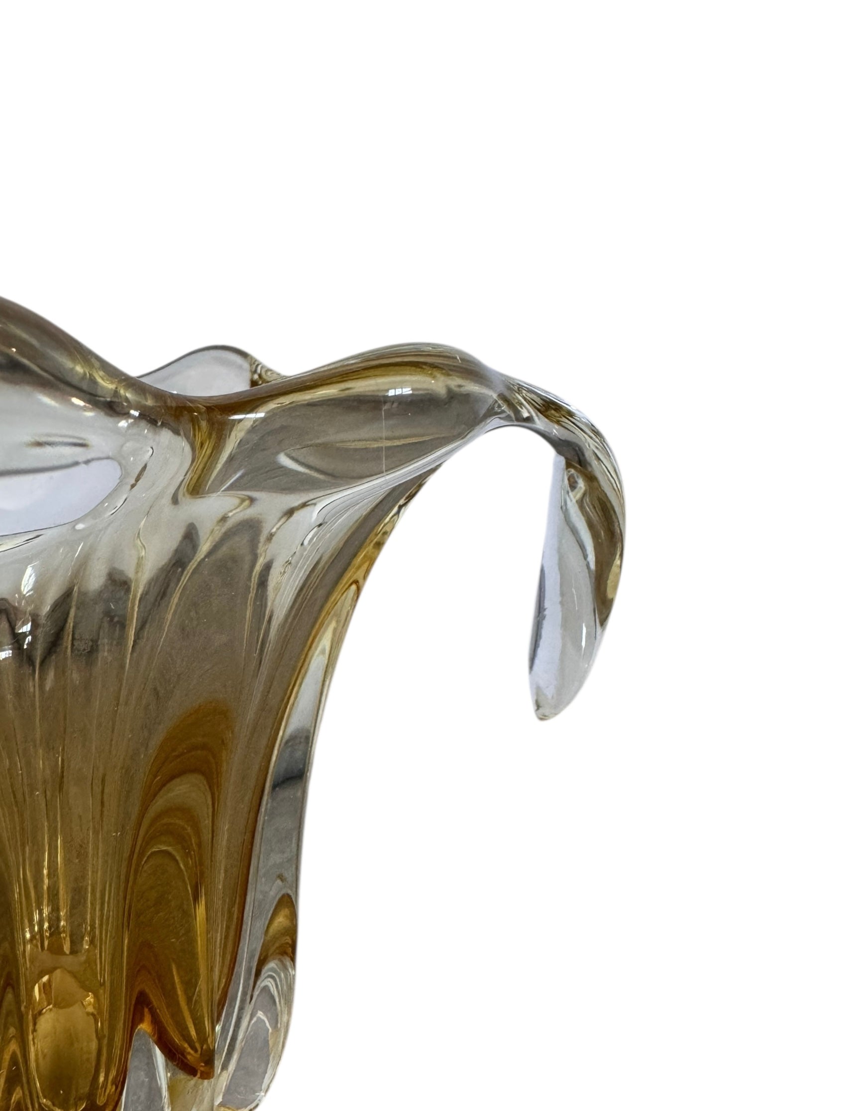 A hand-blown art glass vase with a scalloped, tulip-shaped rim, featuring an amber-to-clear color gradient and a ribbed base