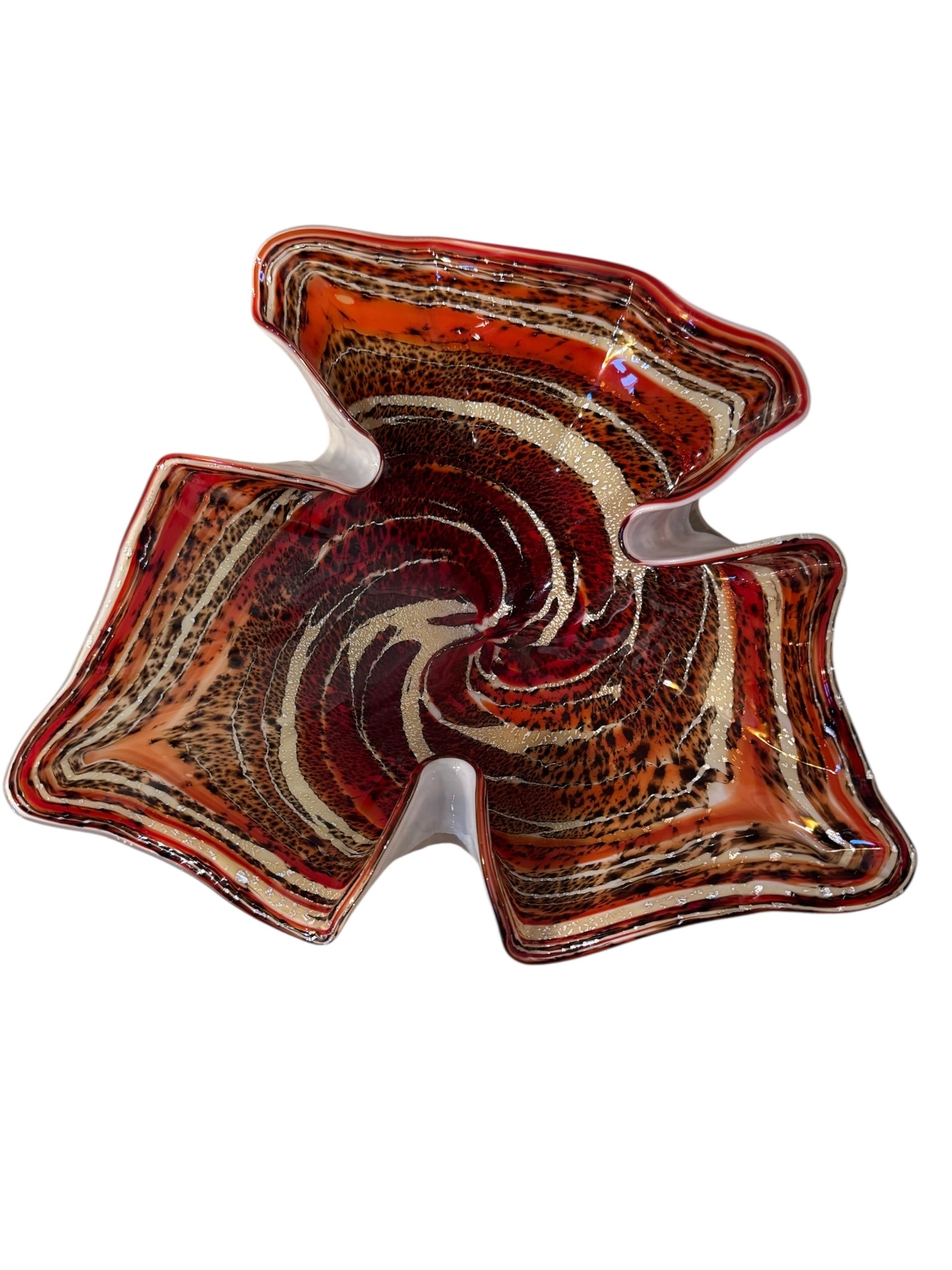 A Murano art glass bowl with a freeform shape, featuring layered swirls of brown, orange, and cream, accented with gold flecks. The bowl has a translucent white base.