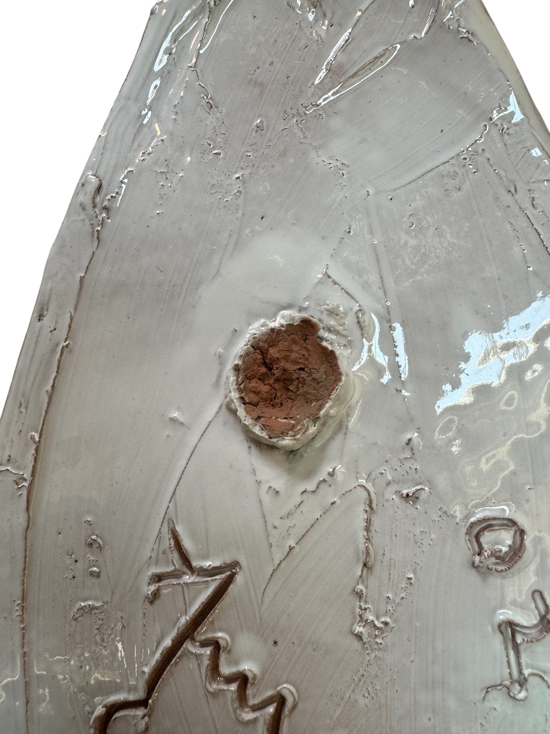 A white and green, glazed ceramic platter in the shape of a prickly pear cactus pad with attached prickly pear fruit. The surface has raised dots representing spines.