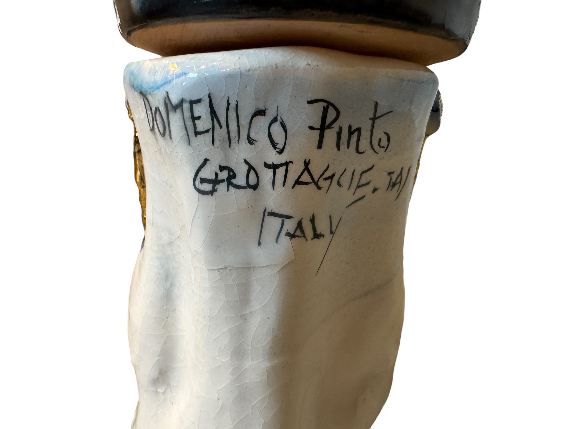 Ceramic foot sculpture by Domenico Pinto featuring hand-painted details, gold accents, a sacred heart, and an angel figure with a blindfold