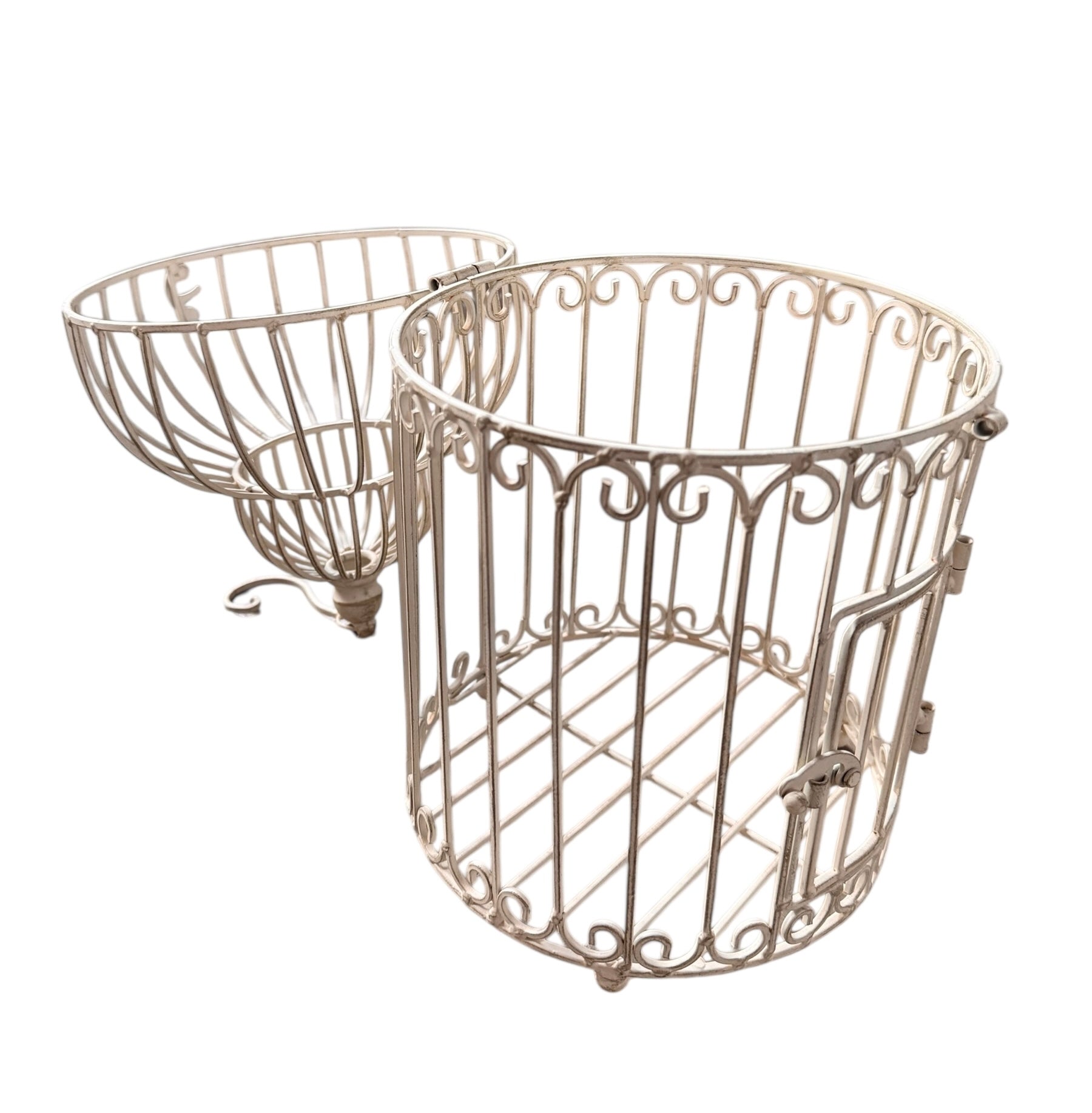 A single, white or cream-colored, decorative wrought iron bird cage with a hinged door and a hanging loop at the top. The cage has a vintage or antique style