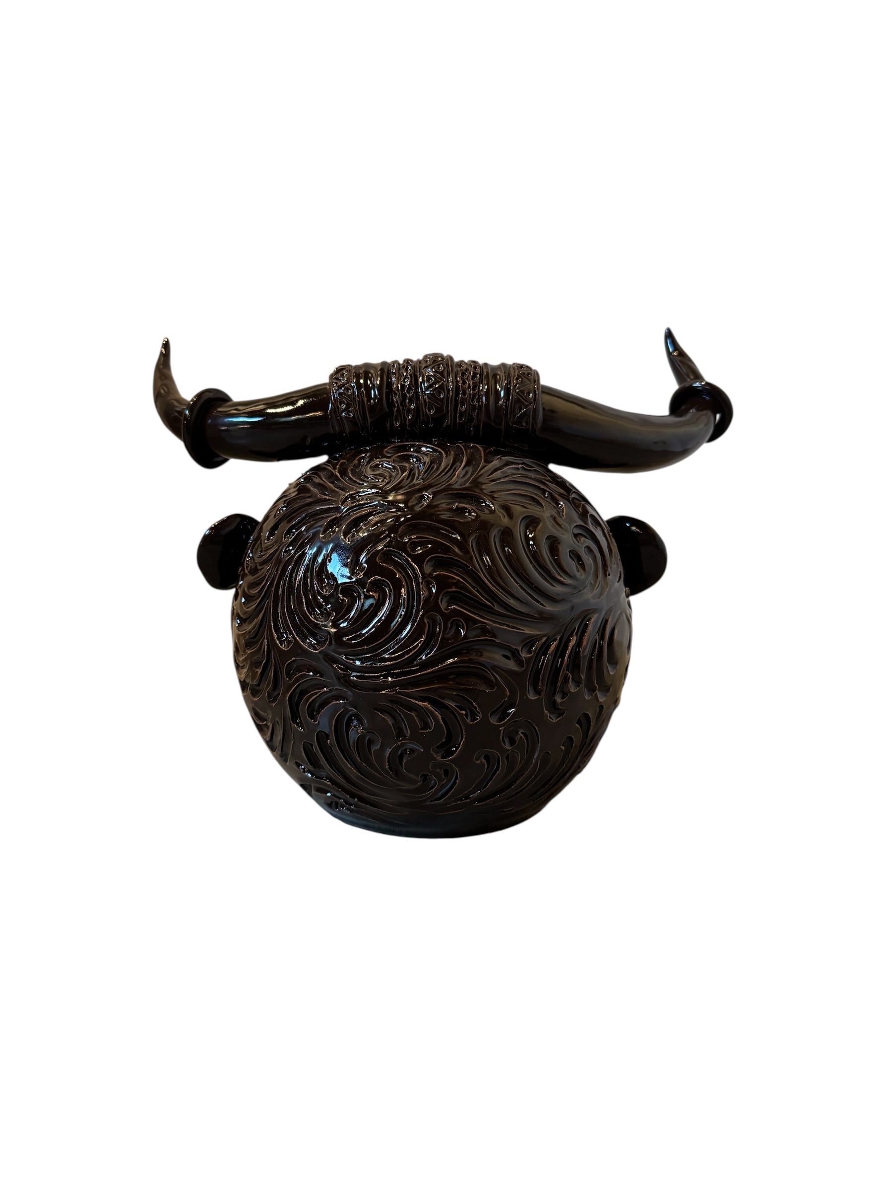Glossy dark brown ceramic bull sculpture with intricate, hand-incised swirling patterns and a nose ring.
