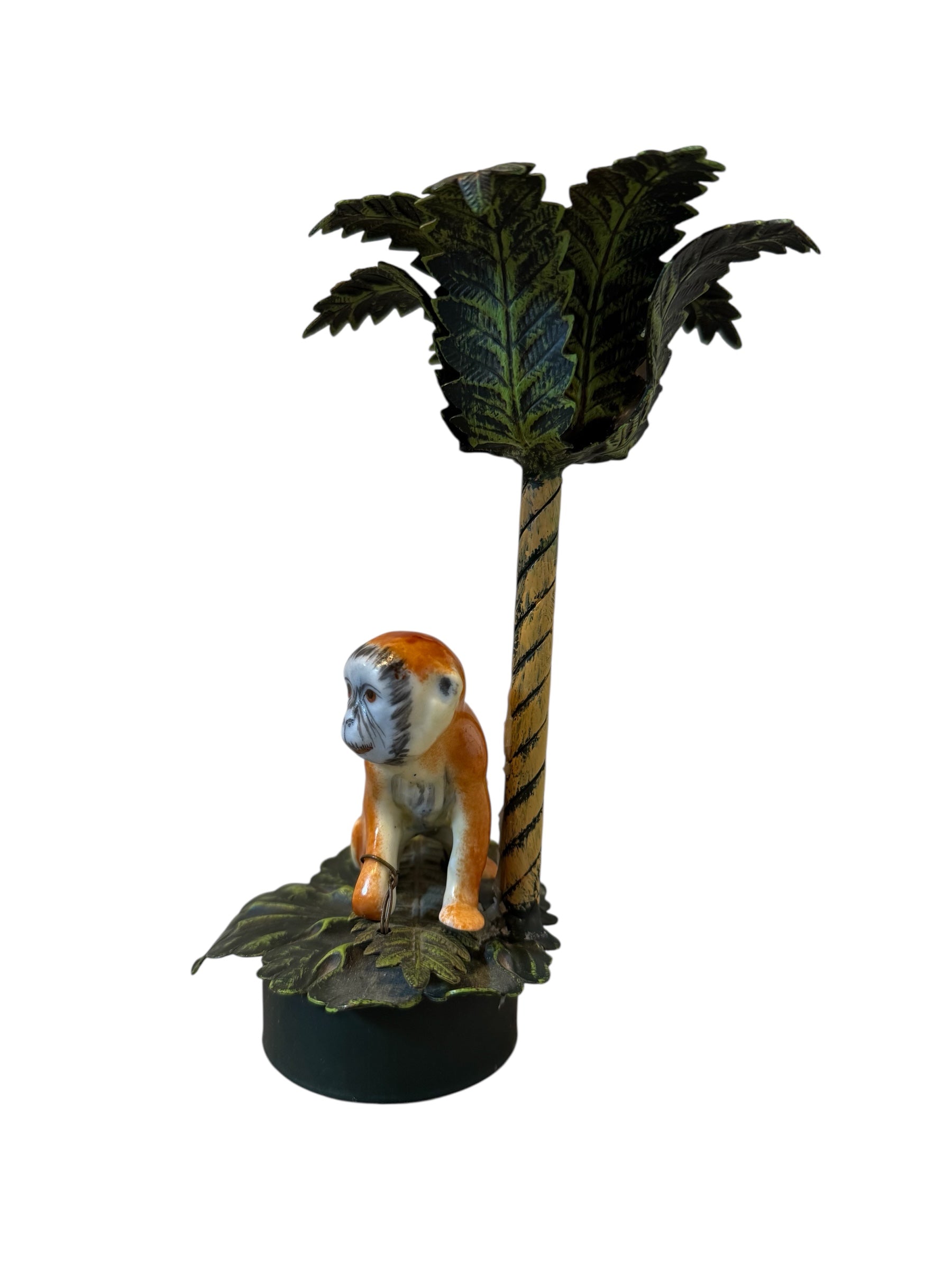Three toleware candlesticks by Petite Choses, each featuring a metal palm tree with painted details and a porcelain monkey figure attached by wire. The candlesticks have a circular iron base.