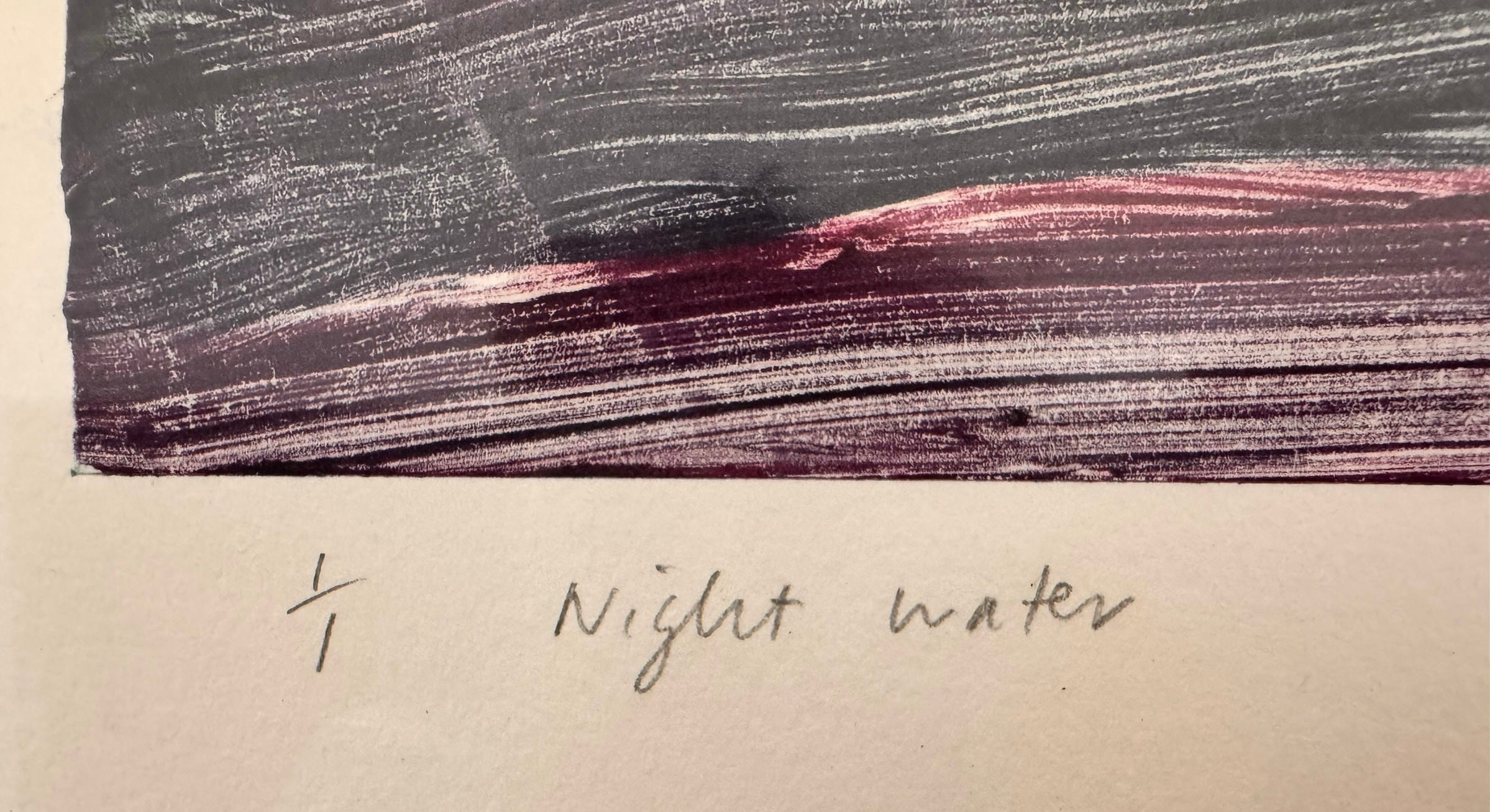 A horizontal, rectangular abstract print titled "Night Water" centered within a white mat and a thin gold frame. The artwork features dense, textured horizontal brushstrokes in deep shades of violet, indigo, and black. A prominent, gestural streak of vibrant red and a softer blush-pink band cut across the dark "water," suggesting a sunset reflection or light hitting a dark surface. The artist's signature, title, and the year 2004 are visible in pencil at the bottom.
