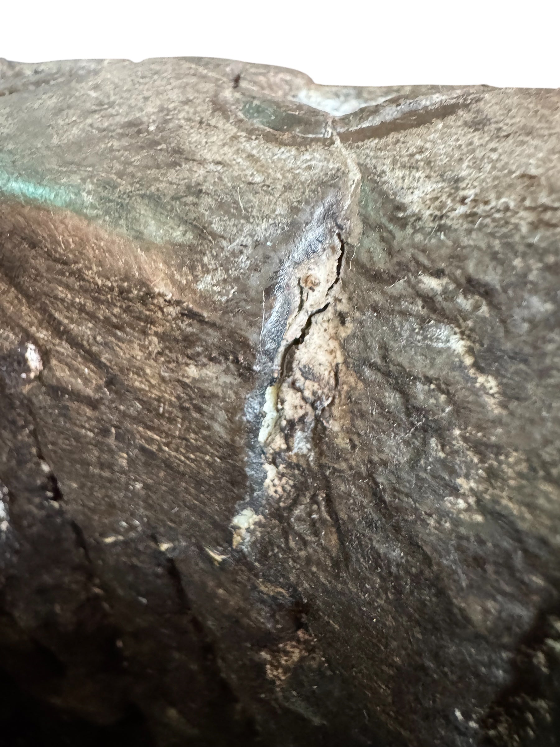 A heavy stone planter, featuring an intricate, hand-carved pattern resembling Celtic knot work.