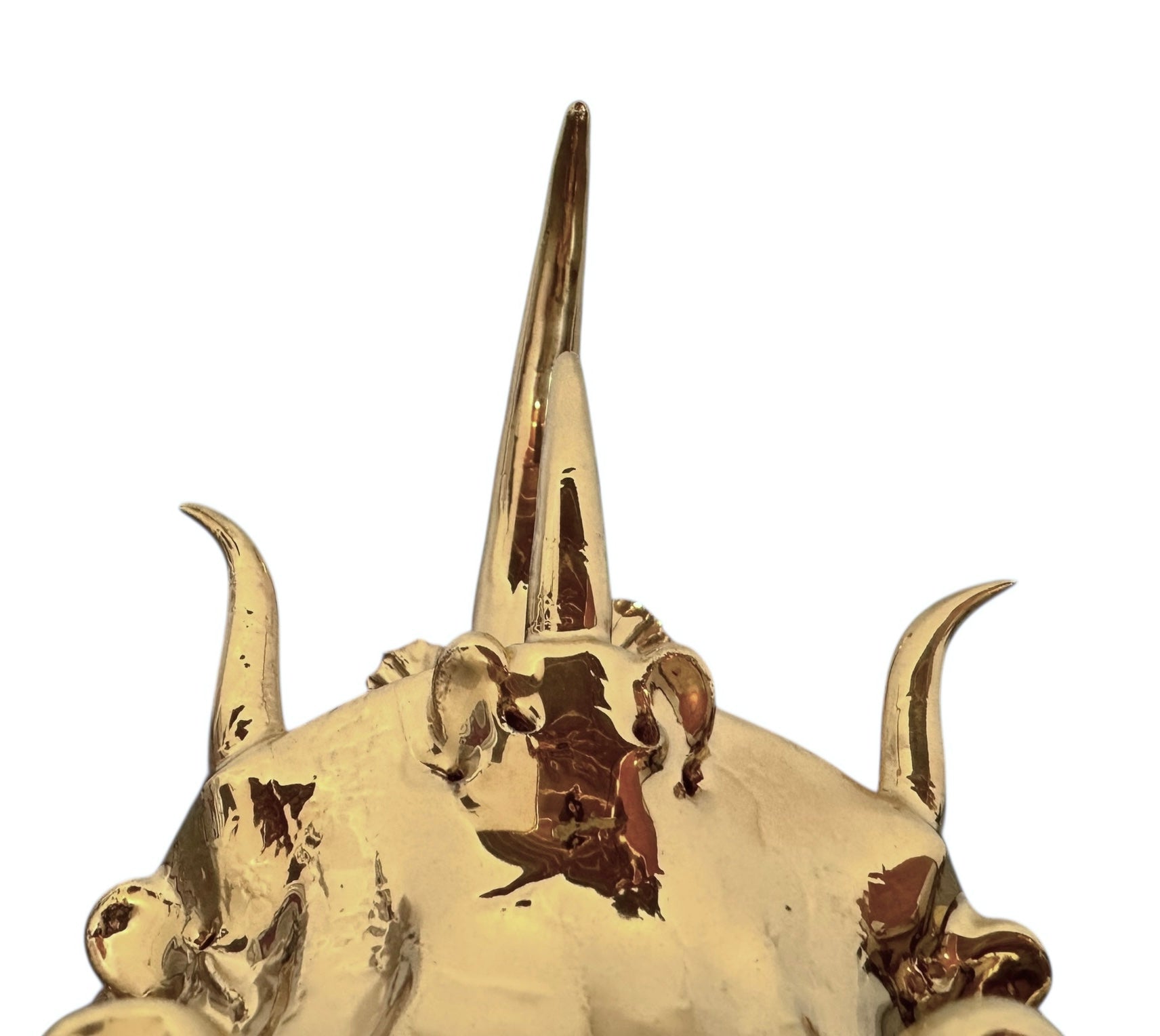 A handcrafted ceramic sculpture of a rhinoceros beetle by Enza Fasano, featuring a brilliant, high-gloss gold metallic finish. The beetle is captured in a dynamic, slightly upturned pose with detailed textures on its ribbed shell and prominent, curved horns. The piece reflects light across its polished surface, showcasing the artist’s signature fusion of traditional Pugliese pottery and contemporary luxury.