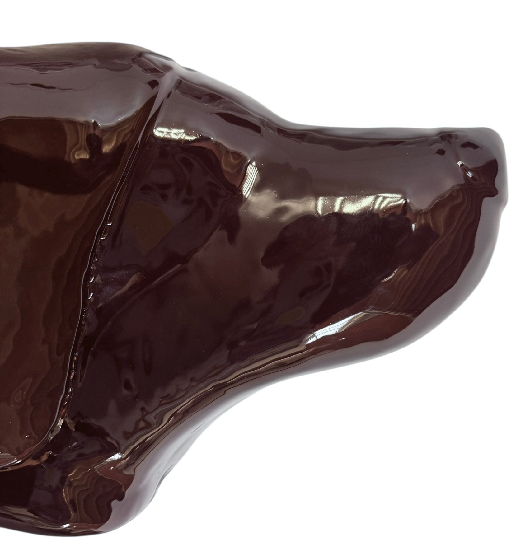 A glossy, dark chocolate brown ceramic bust of a Labrador dog. Created by Enza Fasano, the sculpture features a minimalist, stylized design with smooth, flowing lines and a high-shine glaze that reflects light. The dog’s long ears drape down the sides, and its snout is rounded, capturing the gentle essence of the breed in a contemporary Italian pottery style.