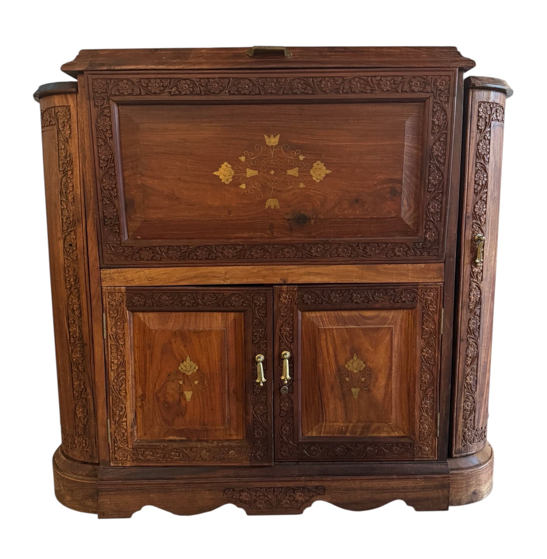 Antique bar cabinet with wood inlay and brass floral details, open to reveal interior shelving and bar storage