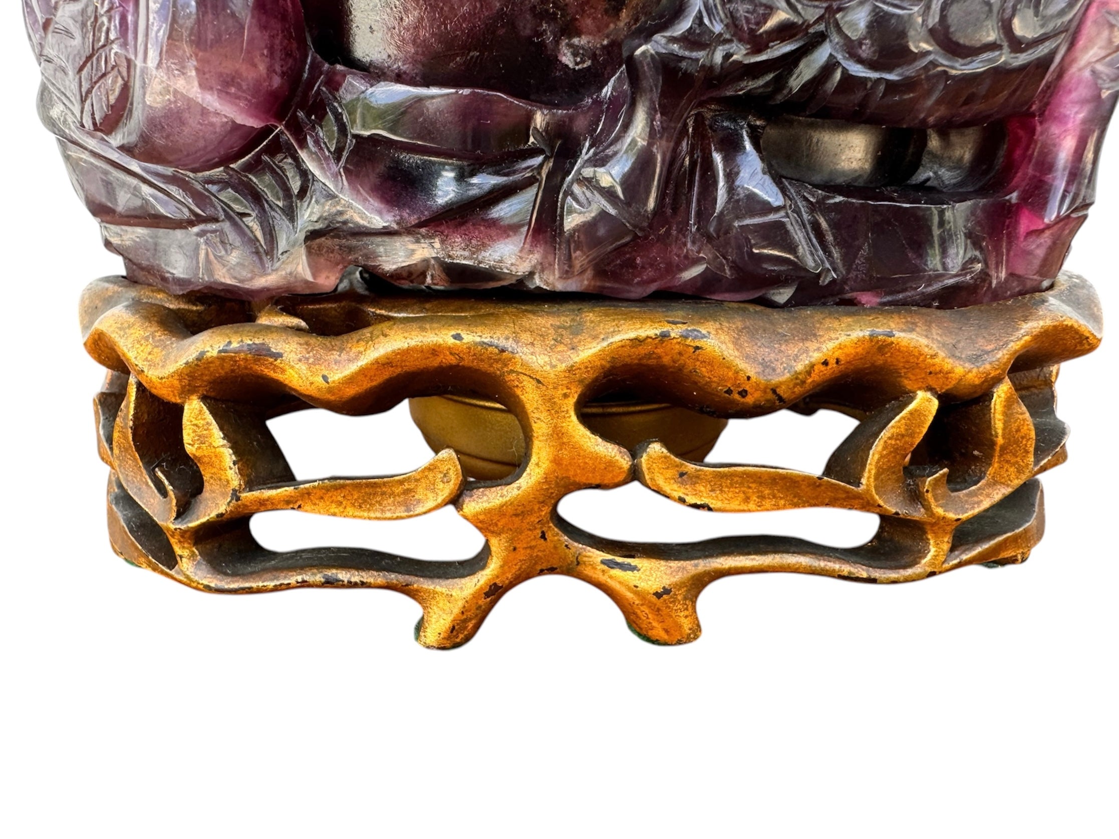An antique Chinese table lamp featuring a base hand-carved from deep purple amethyst stone, topped with a clear quartz crystal neck. The lamp sits on an ornate, custom gilt-bronze Chinoiserie base and features a flared, cream-colored silk lampshade still enclosed in protective plastic. A rectangular brass finial sits at the very top.