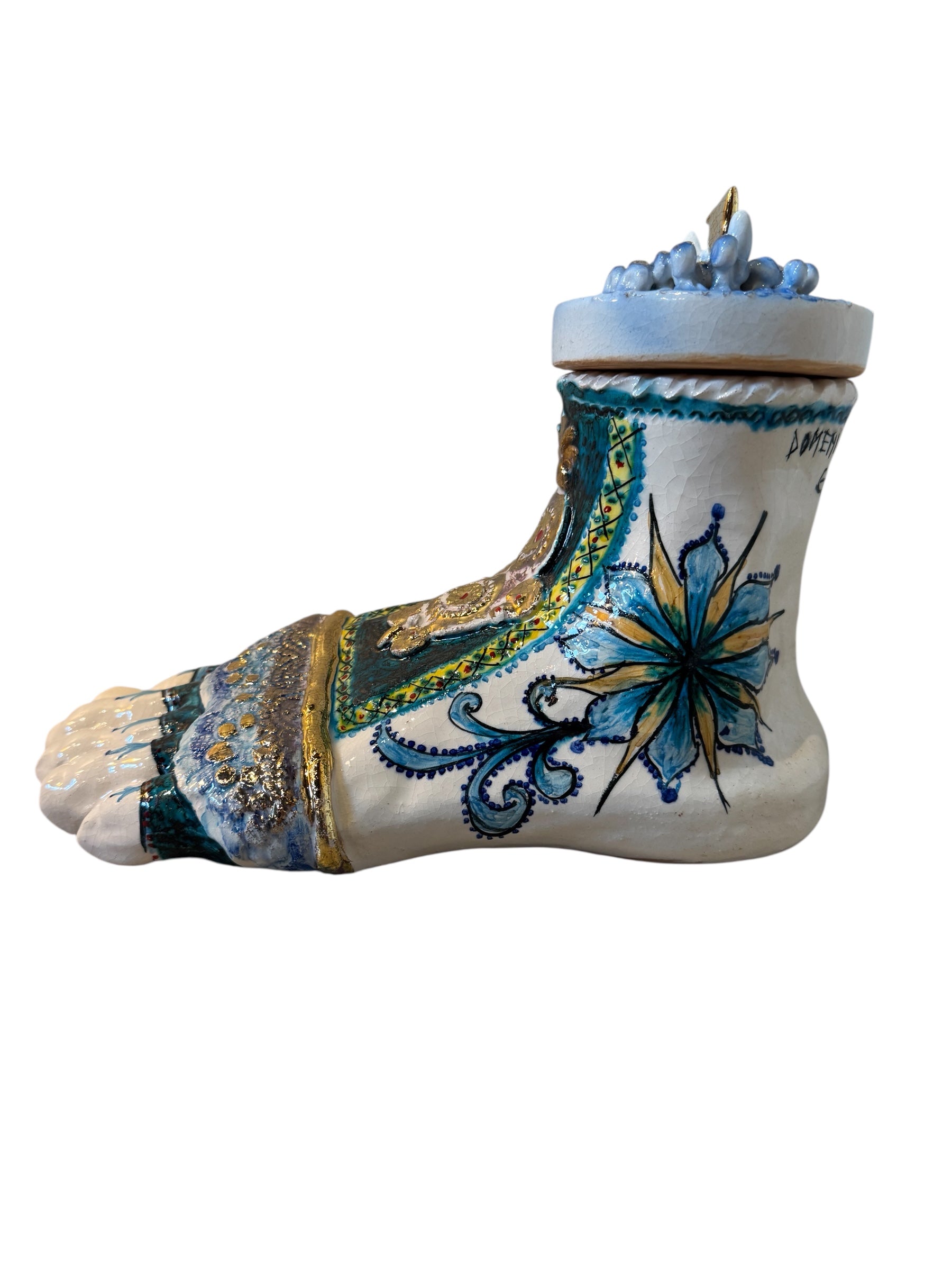 Close-up of Domenico Pinto's 'Mare Dentro' ceramic sculpture: foot, ship with gold sail, Apulian style