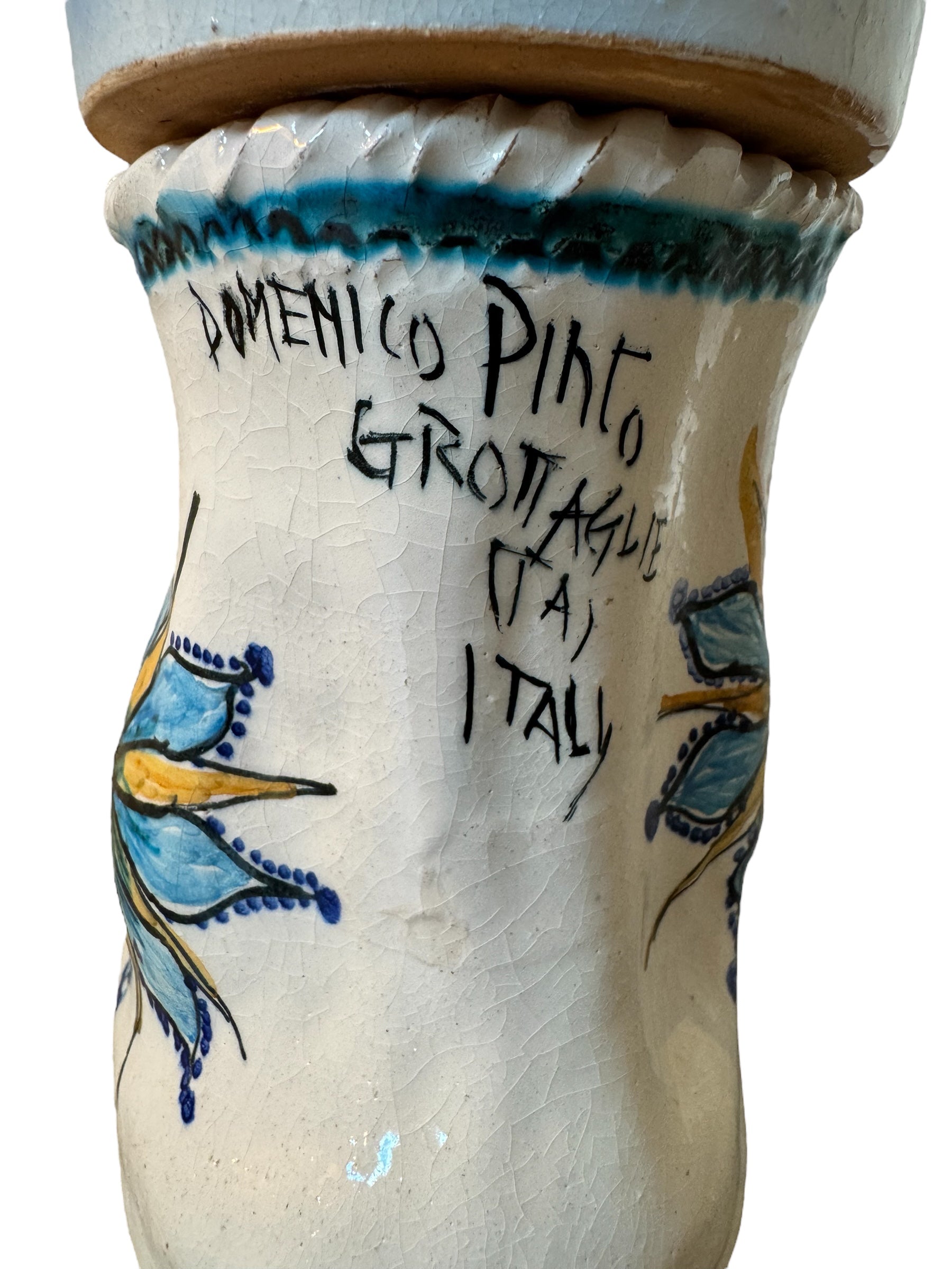 Close-up of Domenico Pinto's 'Mare Dentro' ceramic sculpture: foot, ship with gold sail, Apulian style