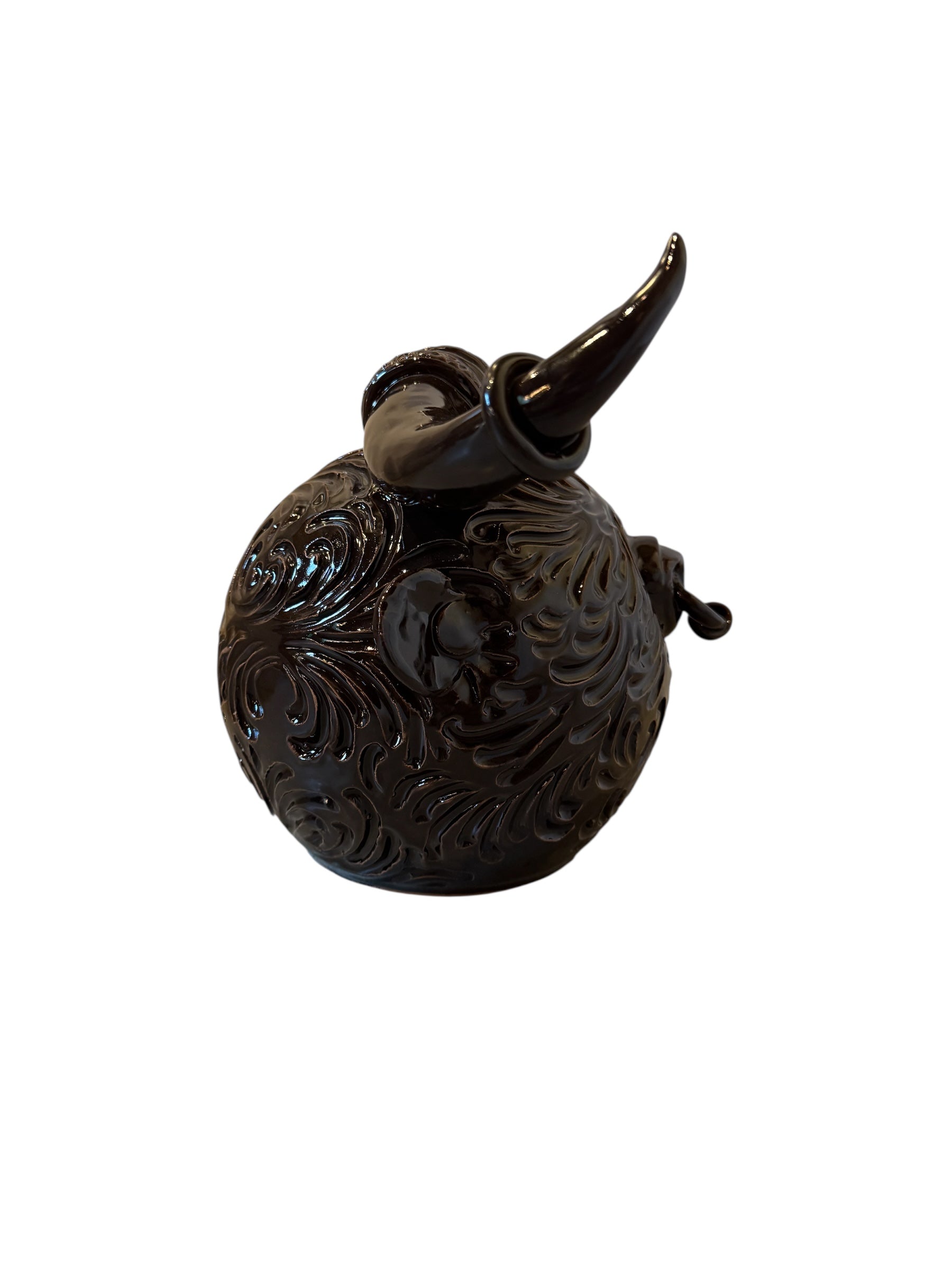Glossy dark brown ceramic bull sculpture with intricate, hand-incised swirling patterns and a nose ring.