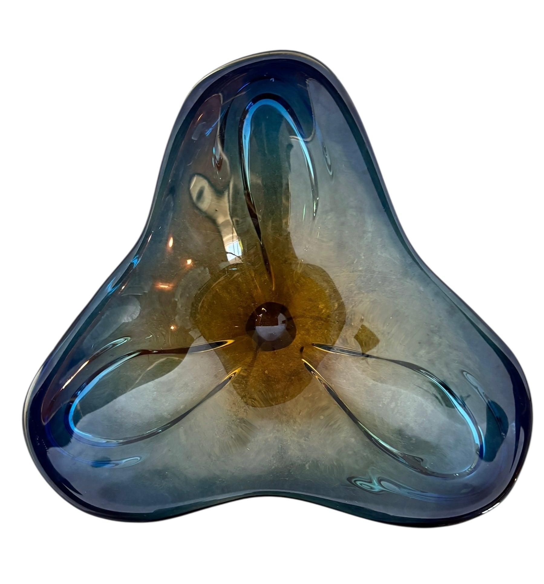 A vintage, hand-blown art glass bowl with a wavy, organic shape and a blue and amber/yellow swirl design