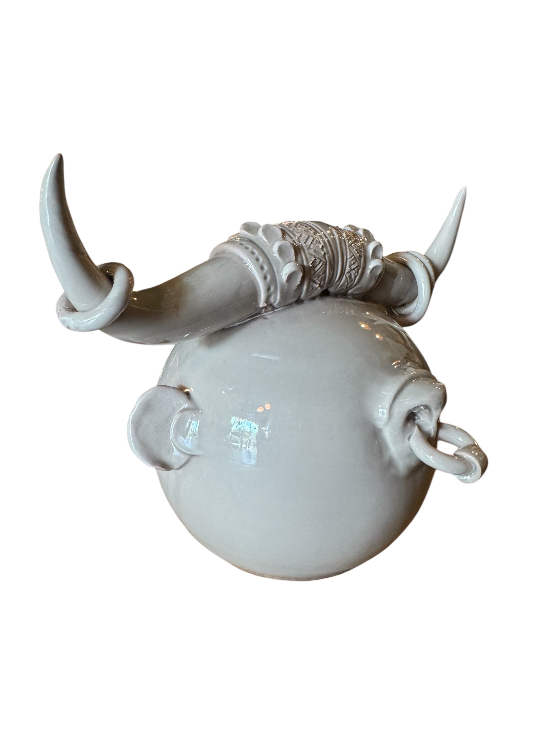 Artistic white grey ceramic bull sculpture by Enza Fasano, featuring a minimalist design and rings on the horns