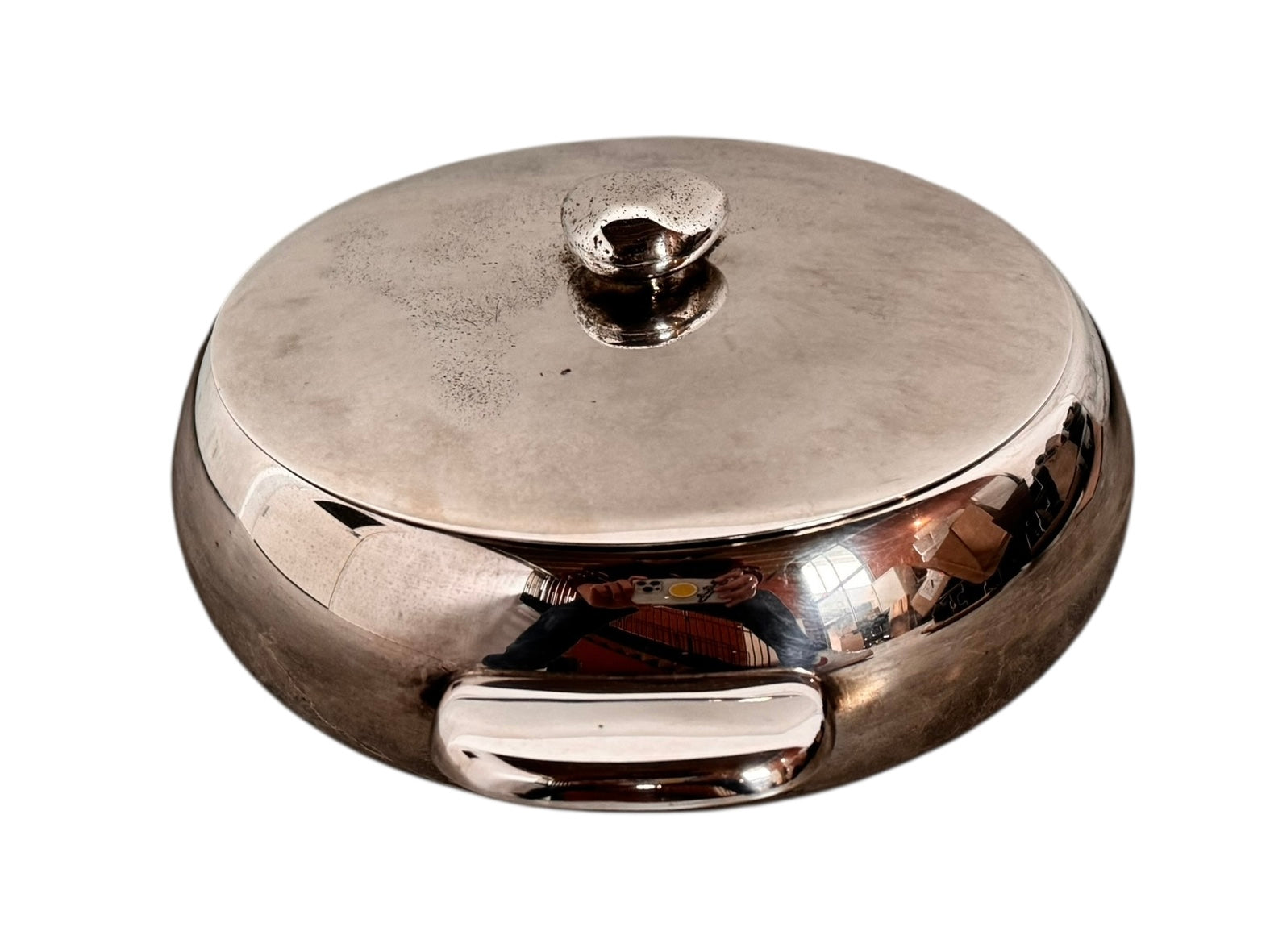 Round St. James silver-plated lidded serving dish from the 1980s, featuring a minimalist modernist design with geometric side handles and a sculptural, biomorphic finial, showing visible vintage wear and pitting on the metallic surface.