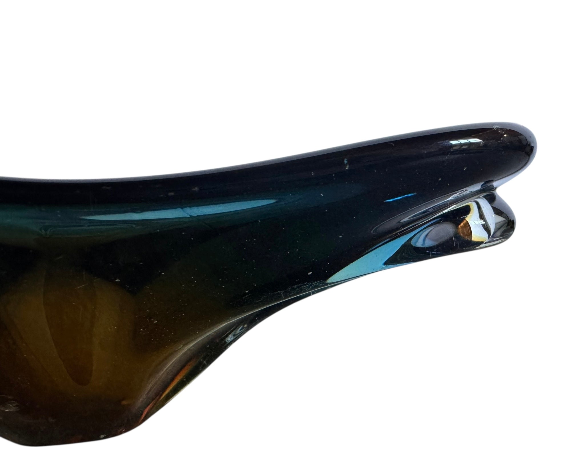 A vintage, hand-blown art glass bowl with a wavy, organic shape and a blue and amber/yellow swirl design