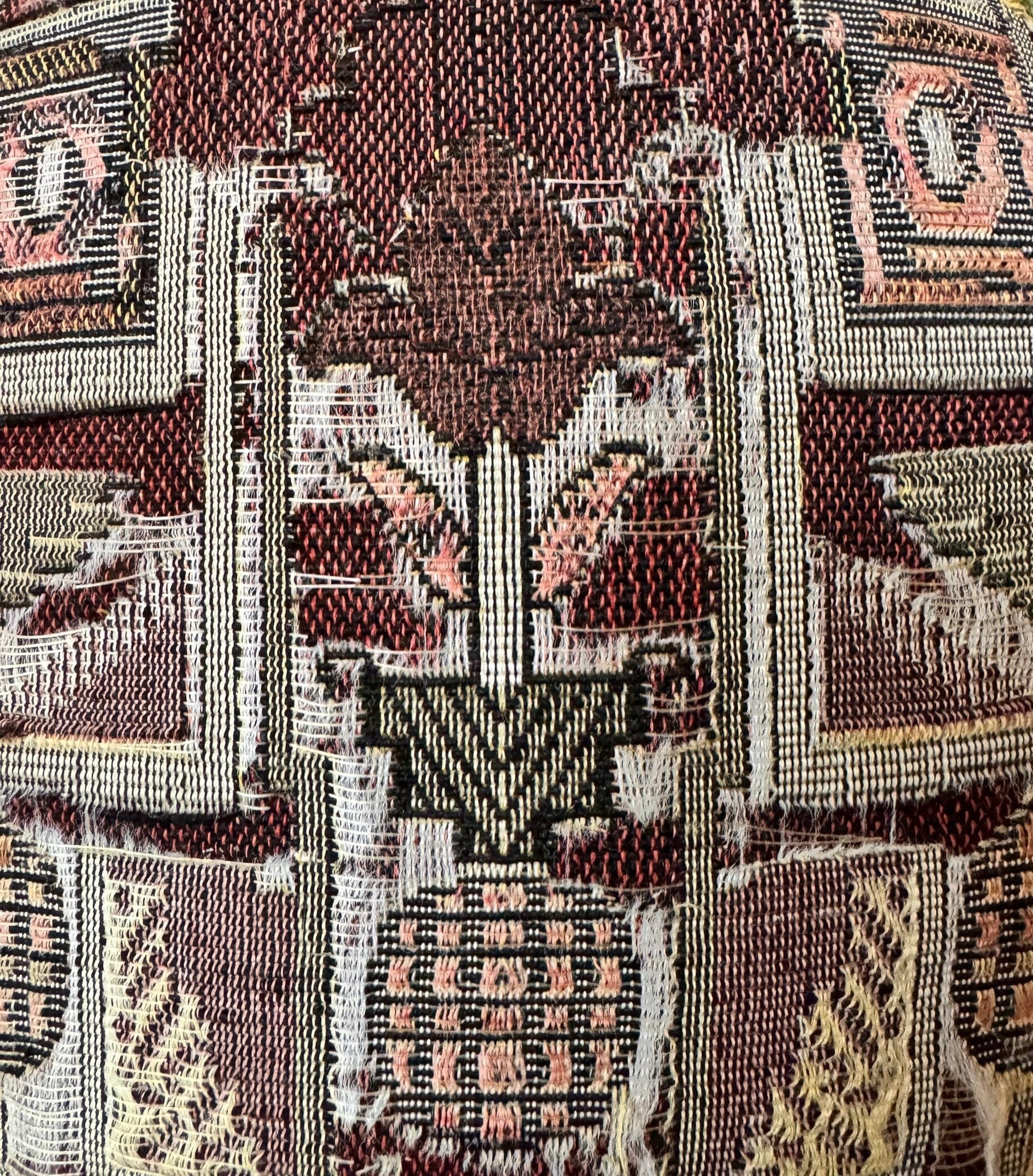 A pair of antique, heavily carved Anglo-Indian style throne chairs featuring lion figures as legs and arm supports, and peacock motifs on the backrests. The chairs have a distressed, multi-colored painted finish.