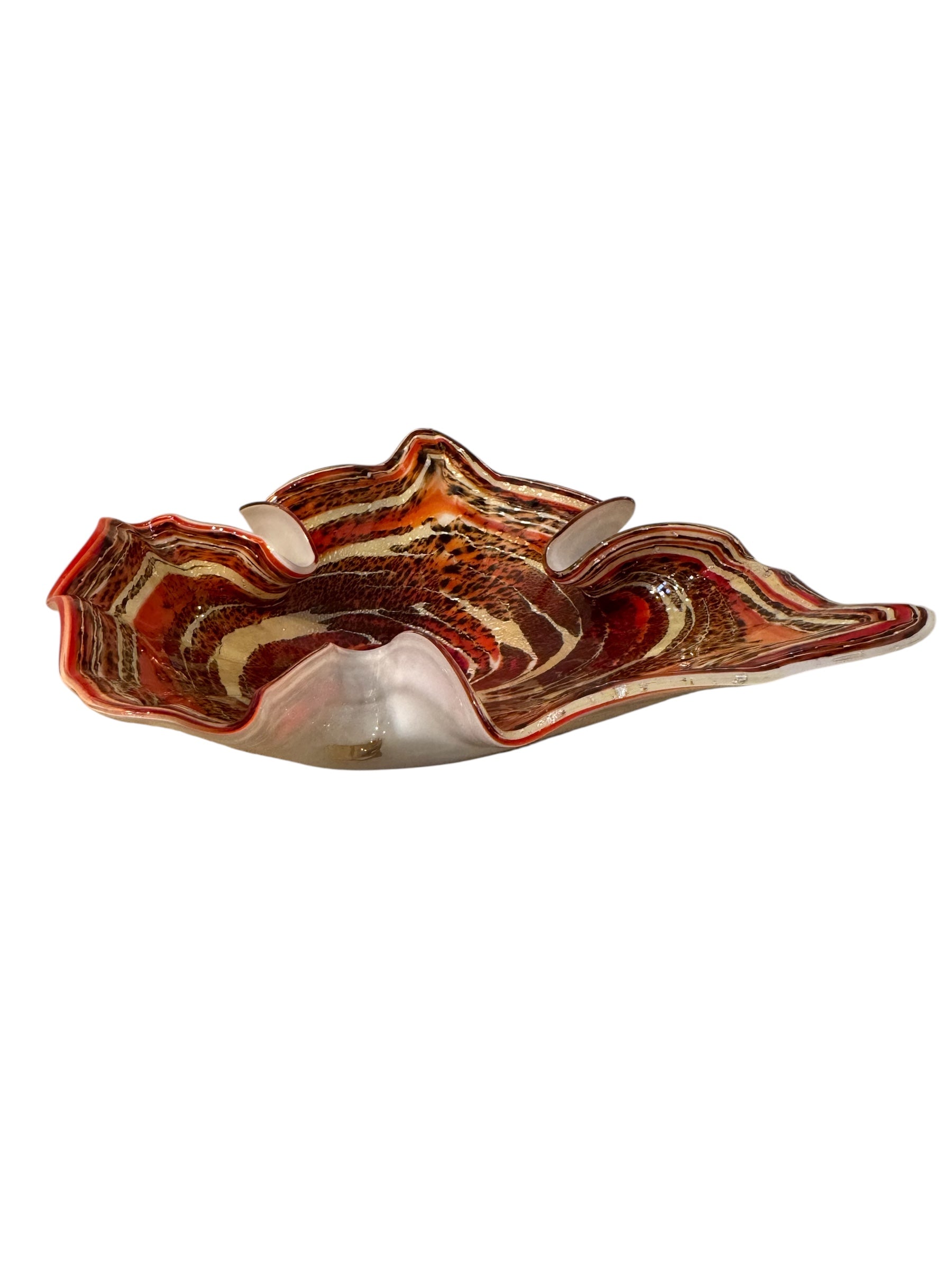 A Murano art glass bowl with a freeform shape, featuring layered swirls of brown, orange, and cream, accented with gold flecks. The bowl has a translucent white base.