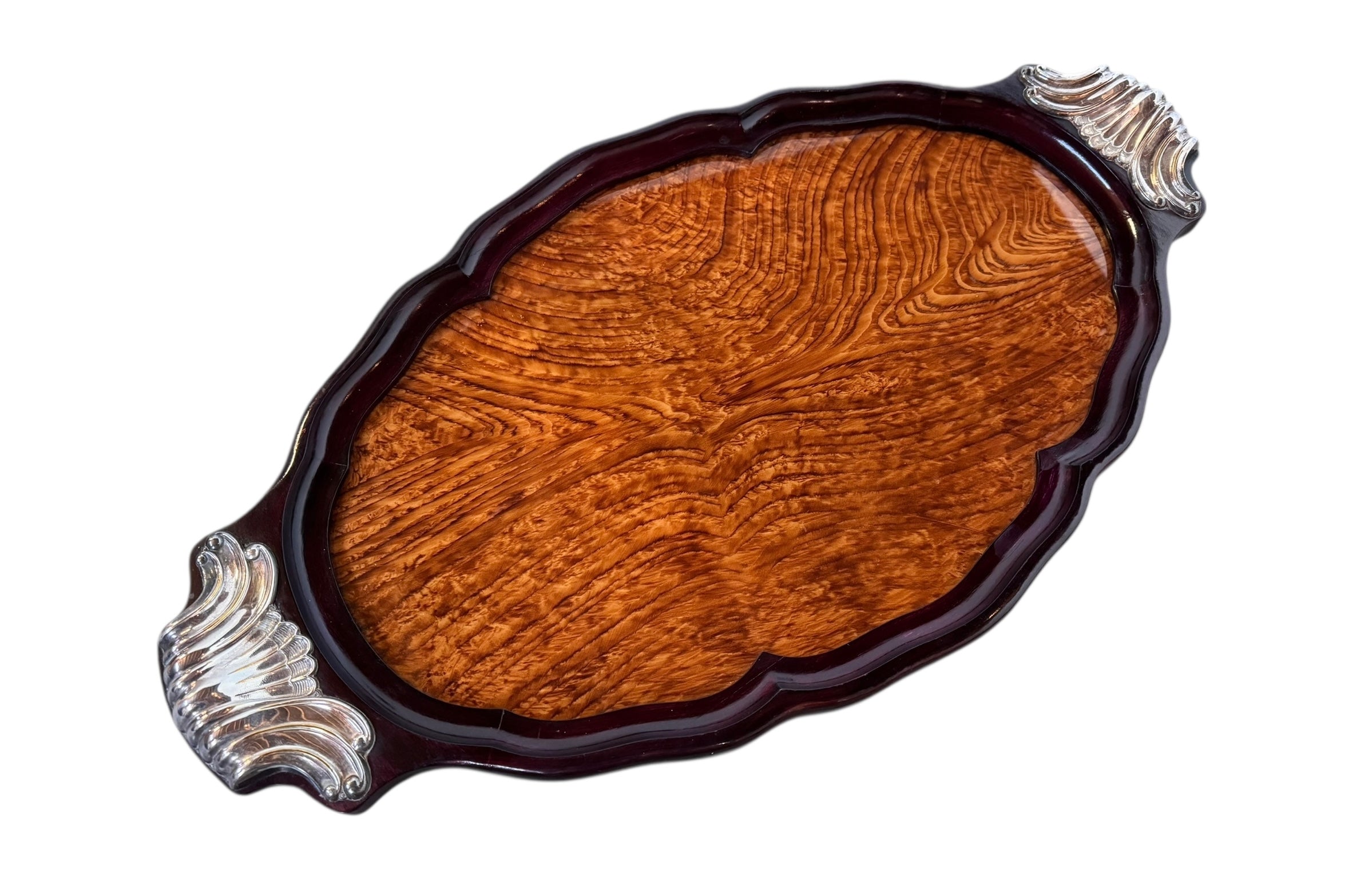 An ornate Art Deco serving tray featuring a highly figured burlwood center and silver-plated handles and rim