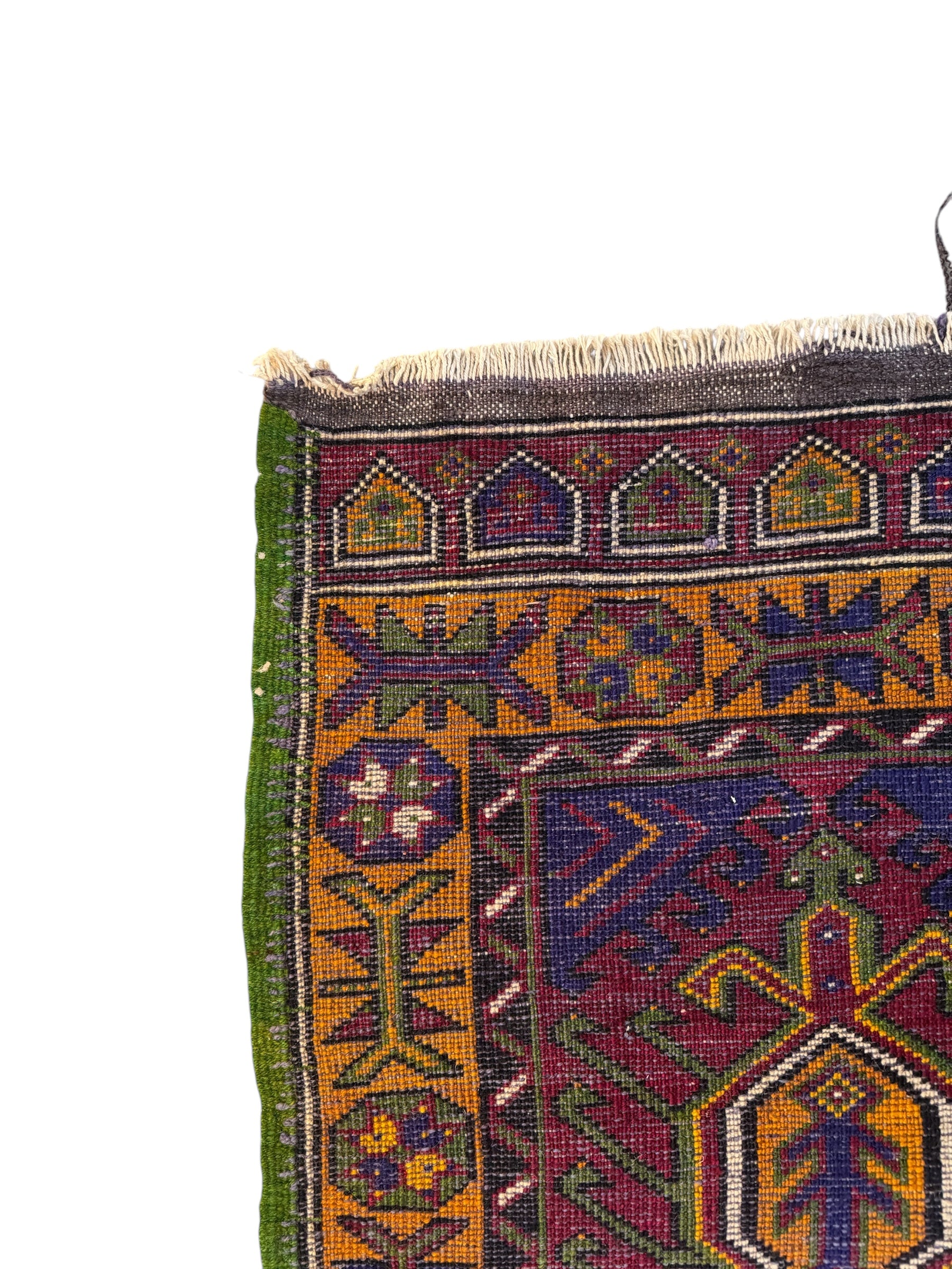 Anatolian Yastik rug with red, gold, green and gray geometric patterns and fringe.