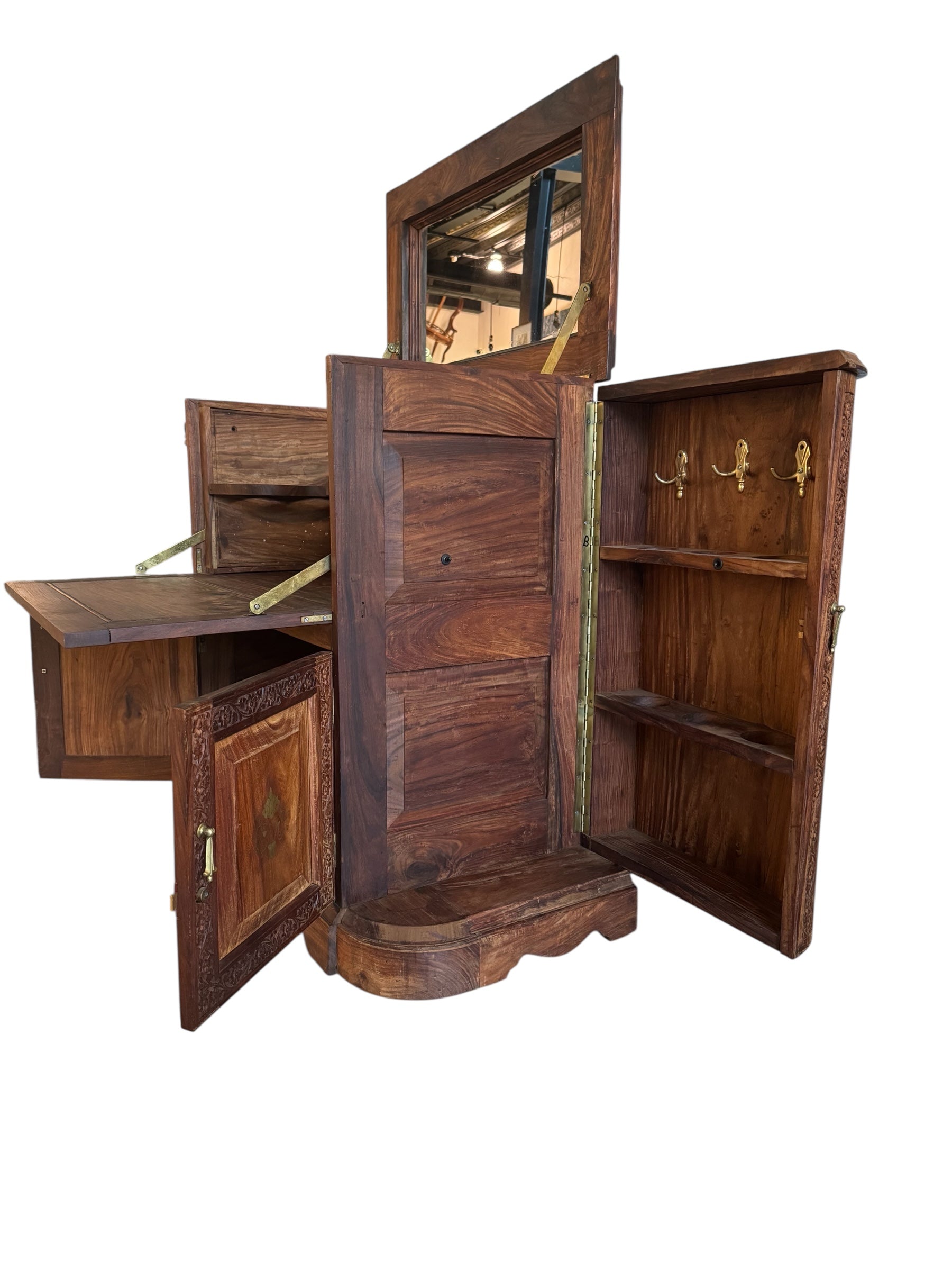 Antique bar cabinet with wood inlay and brass floral details, open to reveal interior shelving and bar storage