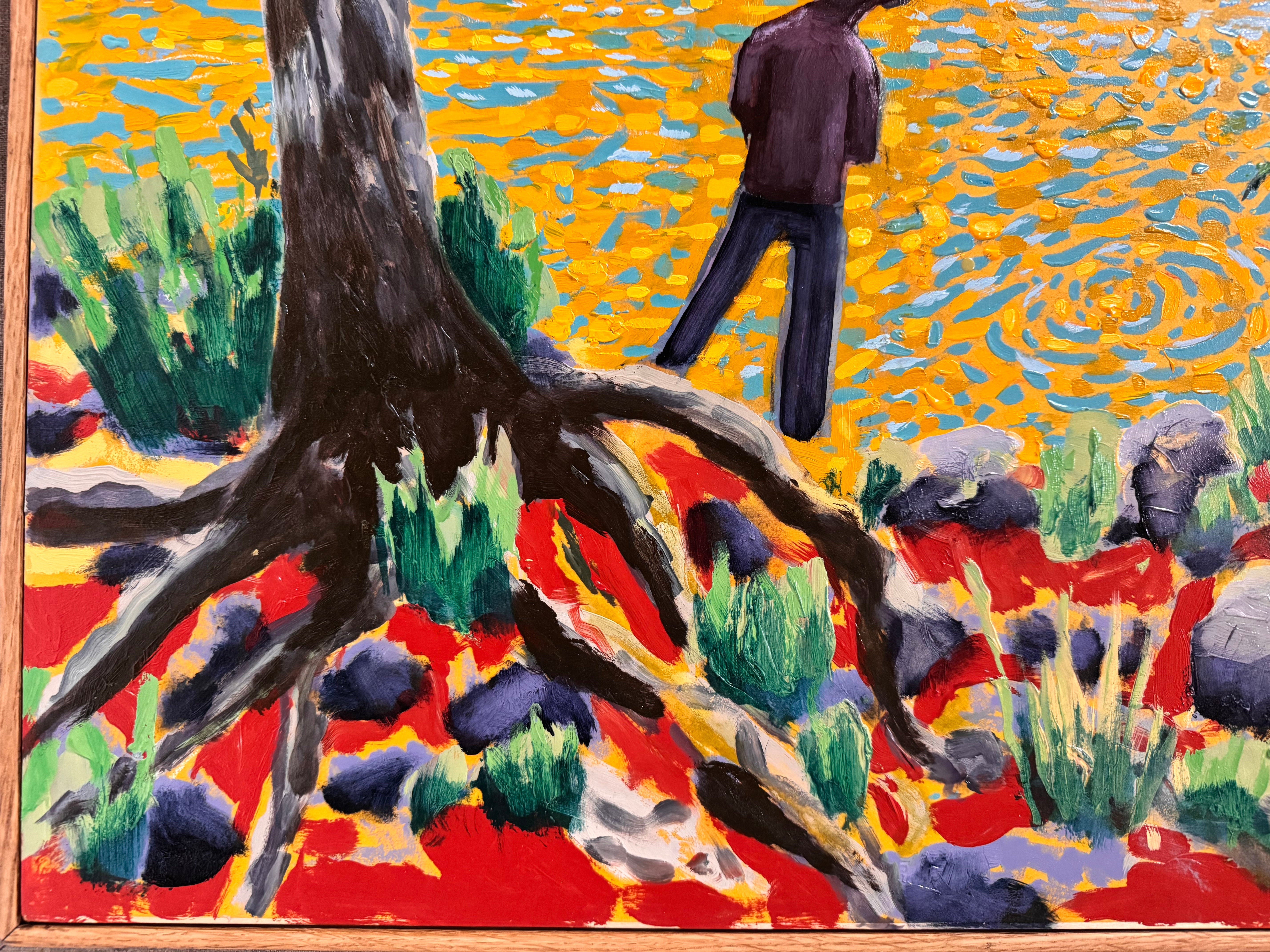 A vibrantly colored landscape painting titled 'Perdernales Falls Fisherman,' featuring two large trees with prominent exposed roots framing a body of water. A lone figure, a fisherman, stands by the water in the middle ground. The painting uses bold strokes of yellow, green, red, and blue, and is enclosed in a rustic dark wooden frame with a light-colored inner mat.