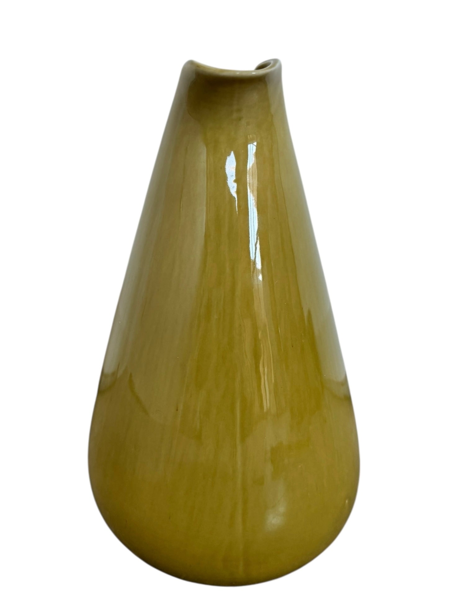 A chartreuse (yellow-green) ceramic pitcher designed by Russel Wright, featuring a teardrop shape, an elongated spout, and a curved handle