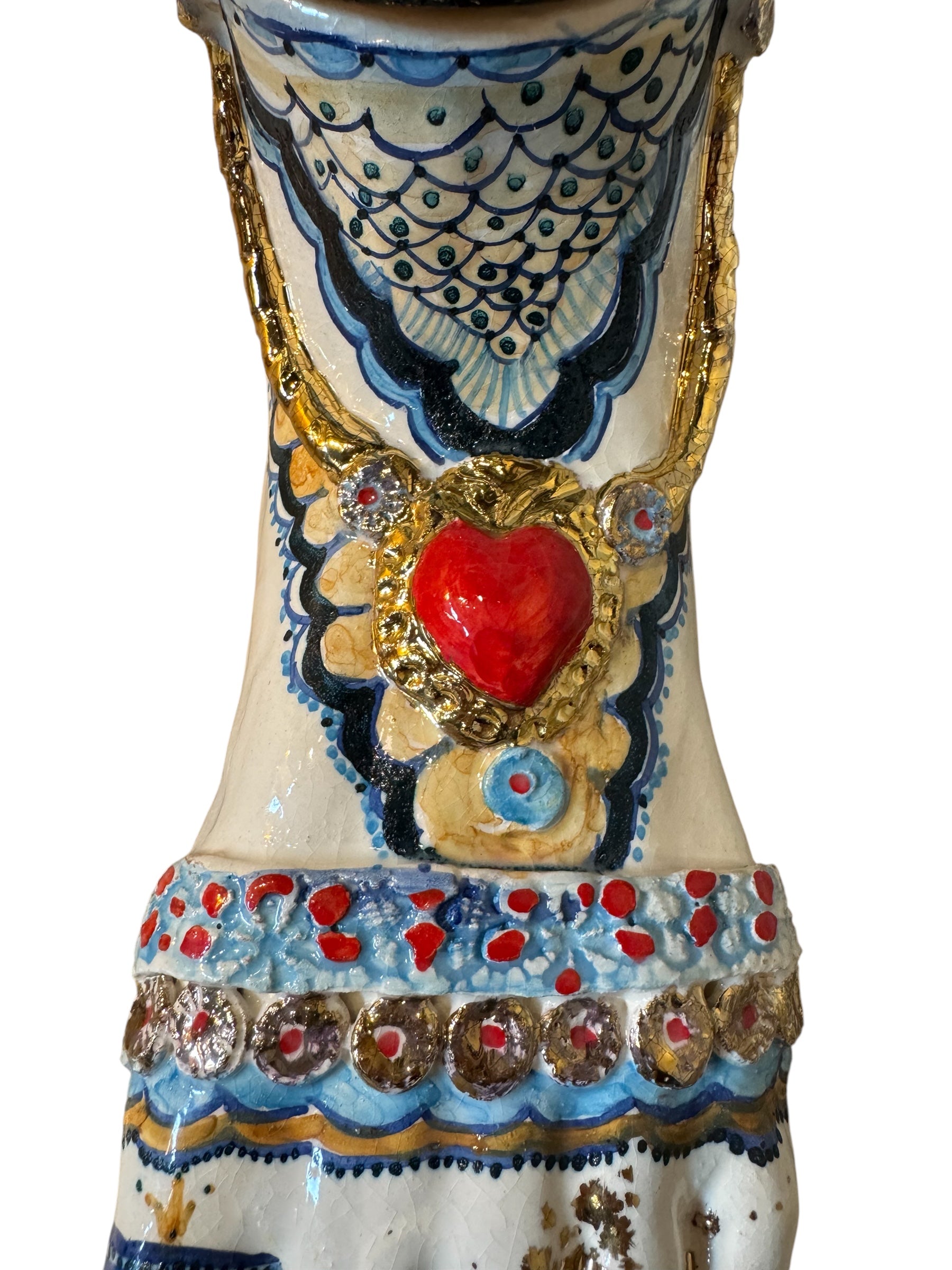 Ceramic foot sculpture by Domenico Pinto featuring hand-painted details, gold accents, a sacred heart, and an angel figure with a blindfold