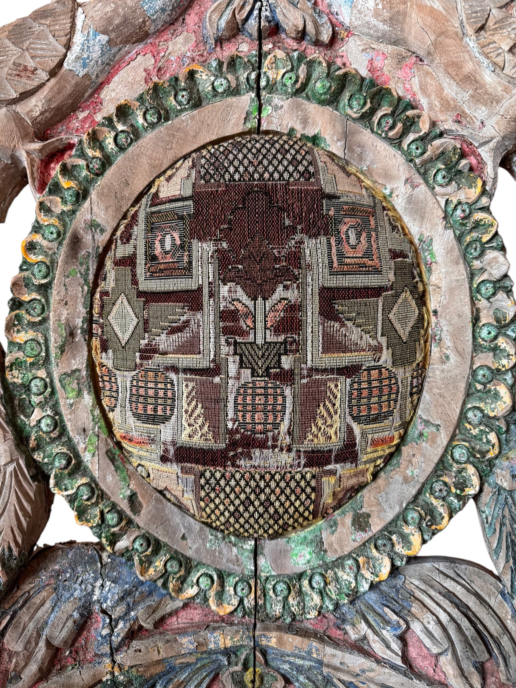 A pair of antique, heavily carved Anglo-Indian style throne chairs featuring lion figures as legs and arm supports, and peacock motifs on the backrests. The chairs have a distressed, multi-colored painted finish.