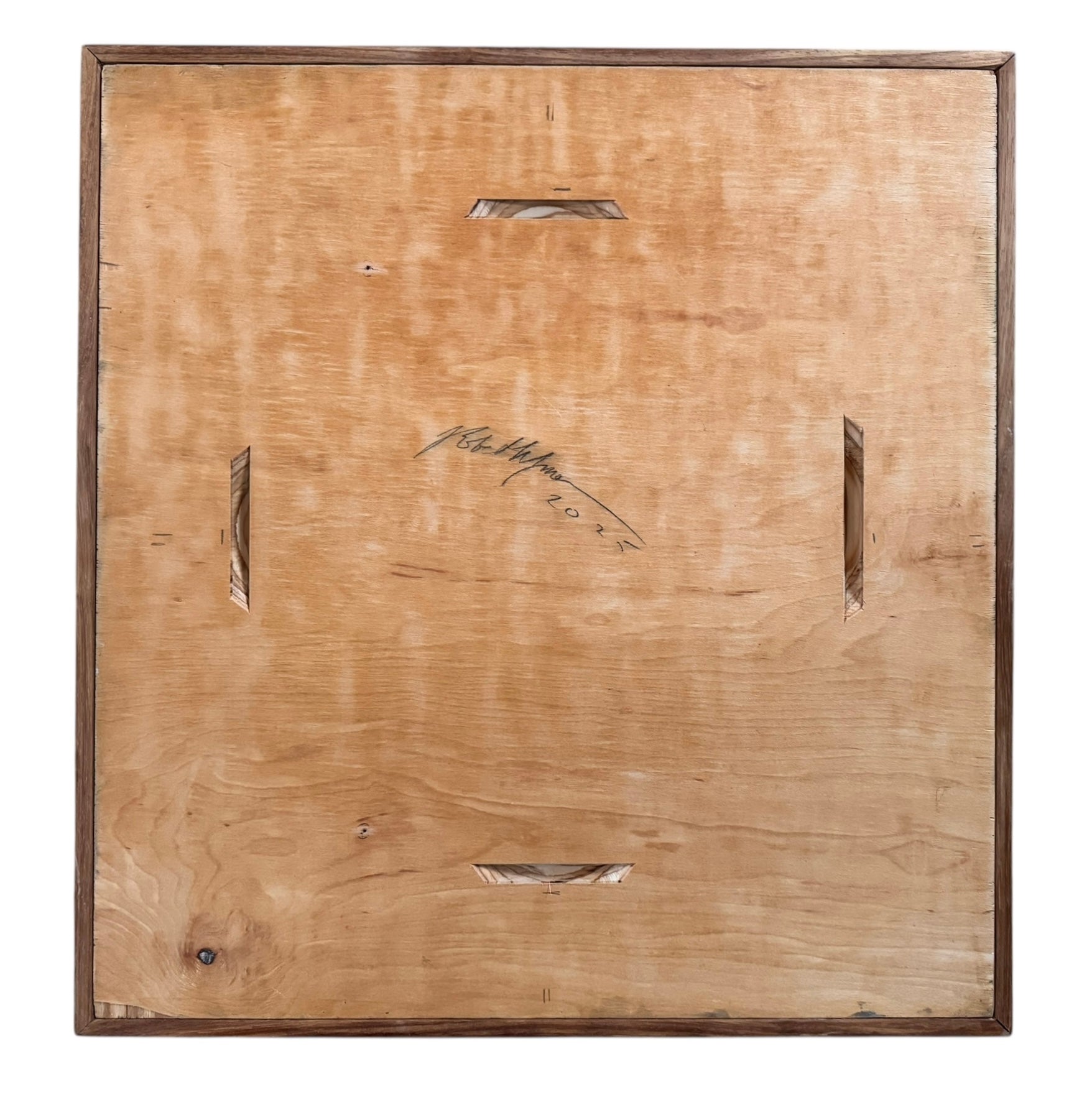 Back of a wooden panel with signature and date