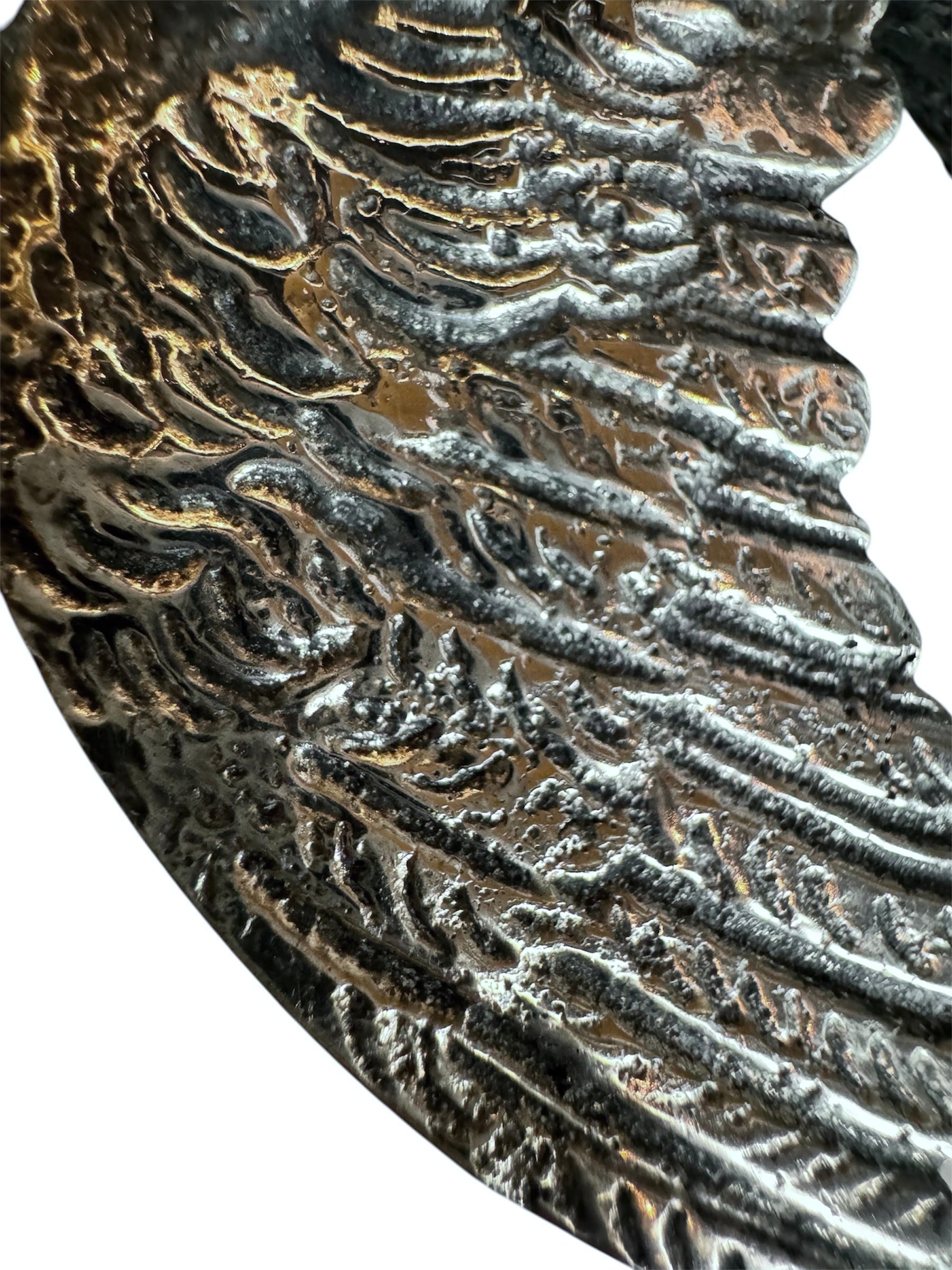 A pair of vintage, silver-plated brass fighting rooster figurines positioned in a confrontational stance against a white background. The rooster on the left is crouched low with its head down and tail feathers fanned high, while the rooster on the right stands more upright with its wings slightly flared. Both feature intricate feather detailing, a metallic patina showing hints of brass through the silver, and small, bright red glass eyes.