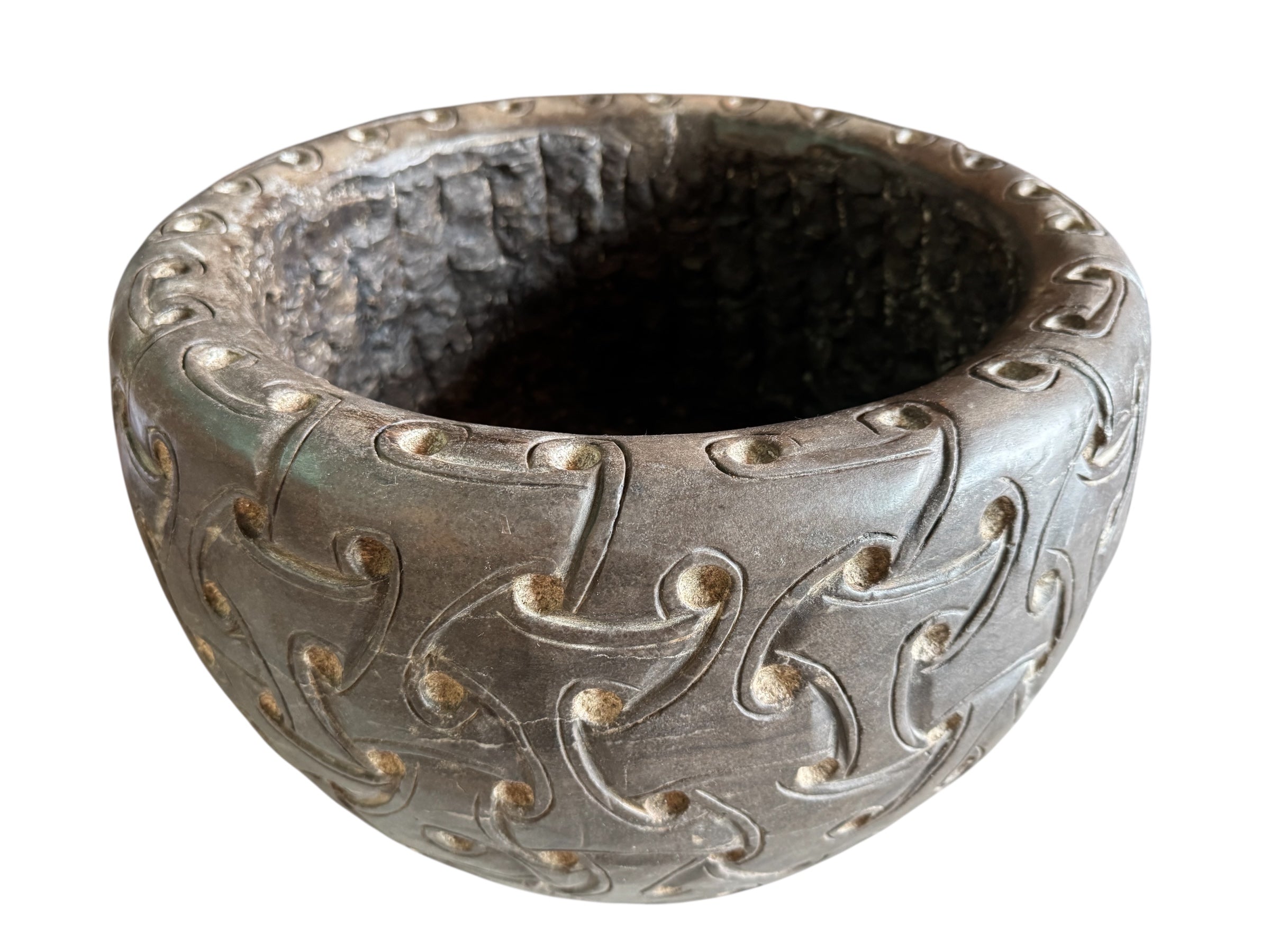 A heavy stone planter, featuring an intricate, hand-carved pattern resembling Celtic knot work.
Carved Stone Planter with Celtic-Style Design