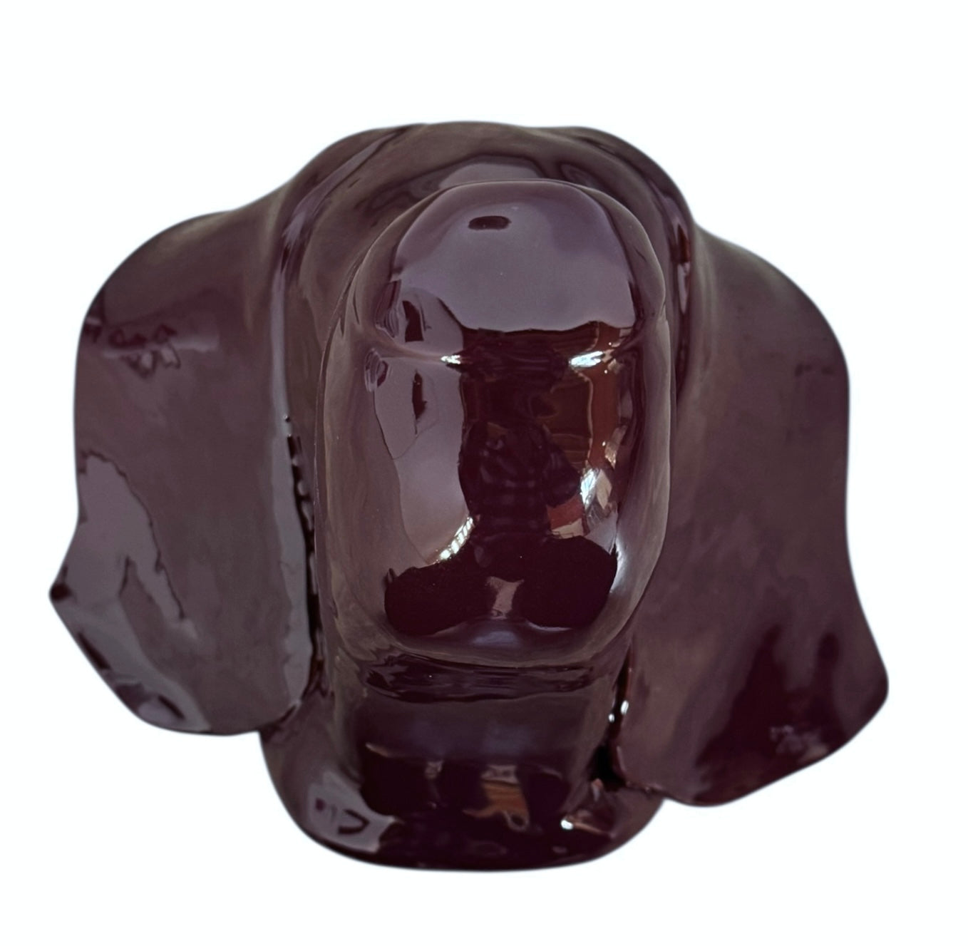 A glossy, dark chocolate brown ceramic bust of a Labrador dog. Created by Enza Fasano, the sculpture features a minimalist, stylized design with smooth, flowing lines and a high-shine glaze that reflects light. The dog’s long ears drape down the sides, and its snout is rounded, capturing the gentle essence of the breed in a contemporary Italian pottery style.