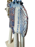 Ceramic horse by Domenico Pinto, featuring a white glazed body, geometric quilting on the saddle, a decorative crown with white and gold accents, and 24Kt gold detailing. The horse stands on four legs and is placed on a white base.