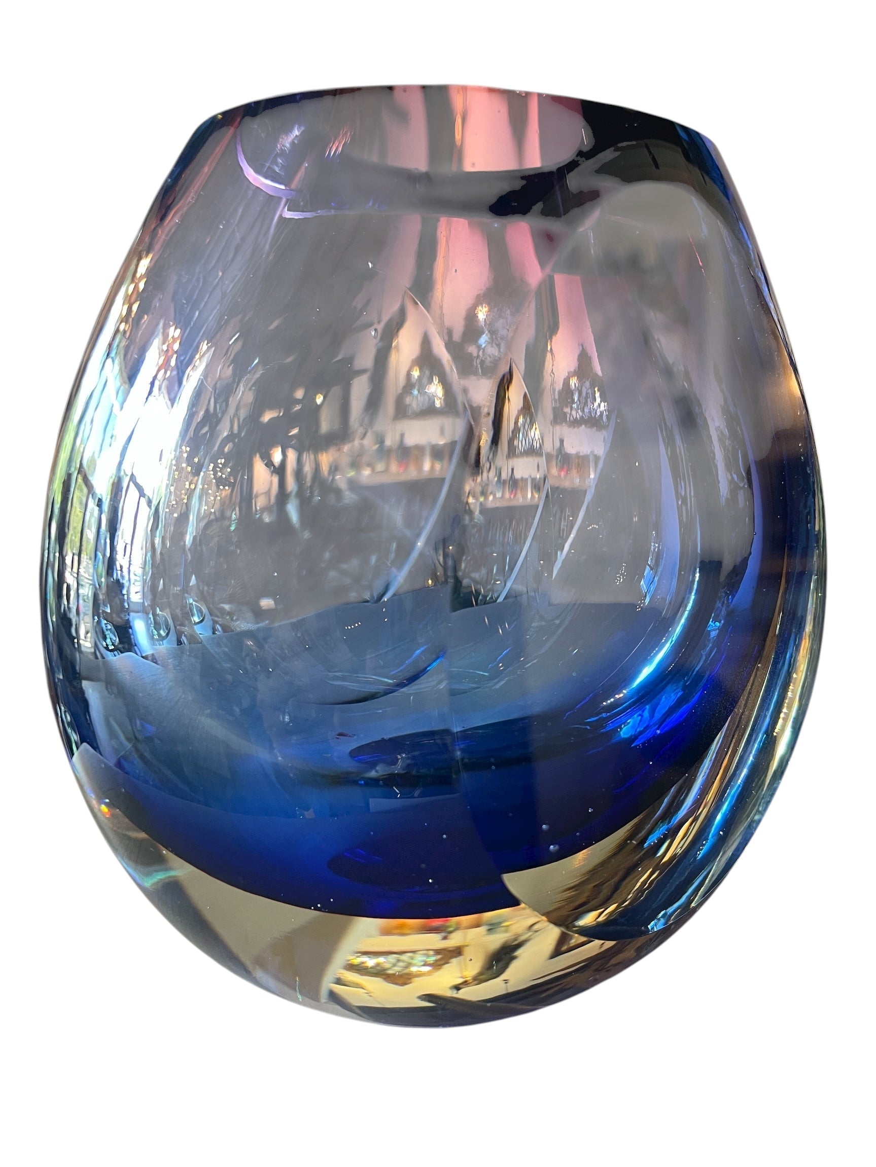 Sommerso glass vase with flattened sides creating a fish-eye effect, featuring cobalt and indigo colors and internal bubbles.