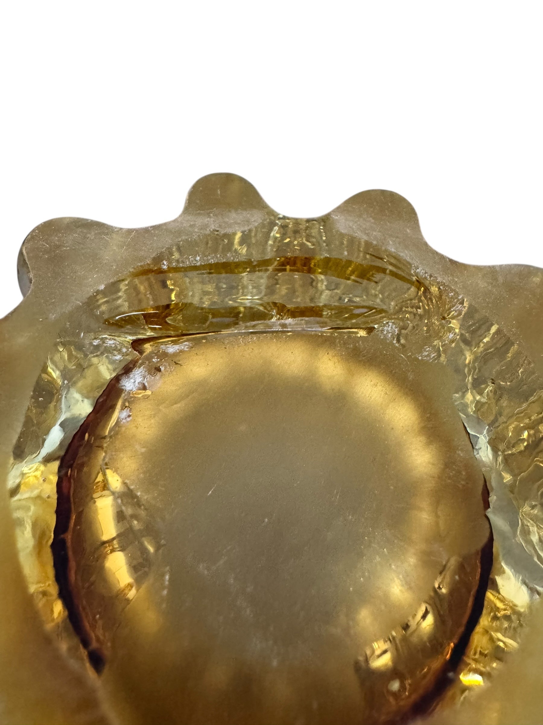 A hand-blown art glass vase with a scalloped, tulip-shaped rim, featuring an amber-to-clear color gradient and a ribbed base