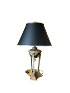 A 19th-Century Ormolu Table Lamp with a black and gold lampshade, featuring a bulbous stand with acorn and paw details, supported by winged caryatids.