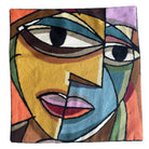 Face motif. Vibrant cross-stitched pillows from India with various artistic designs, sourced in Aix-en-Provence.
Exquisite Cross-Stitched Pillows: A Global Fusion of Color and Craft