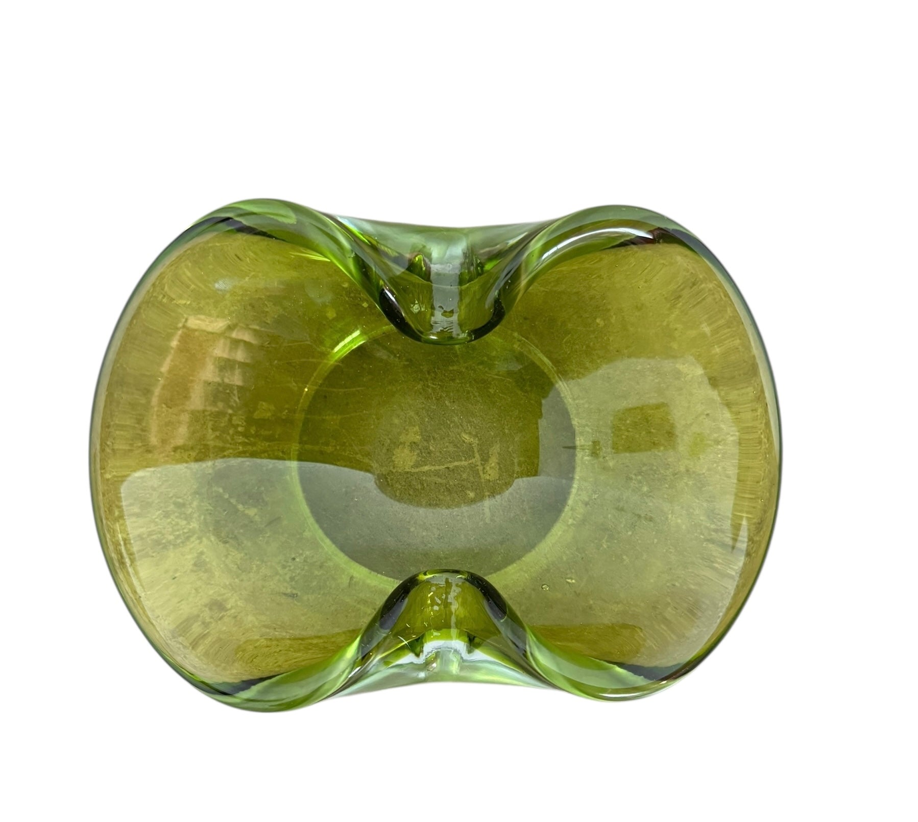 A vintage, Mid-Century Modern, peridot green art glass ashtray or catchall bowl with a curved, free-form design.