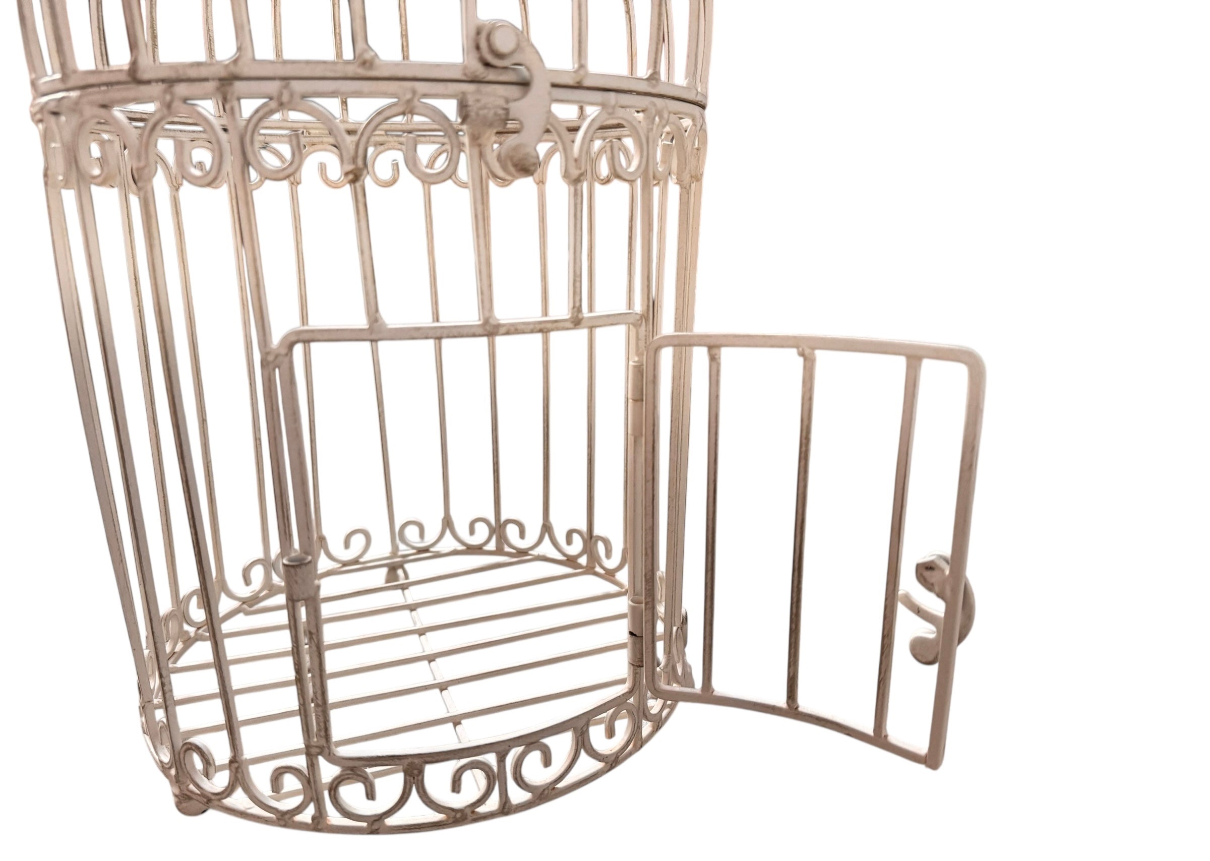 A single, white or cream-colored, decorative wrought iron bird cage with a hinged door and a hanging loop at the top. The cage has a vintage or antique style