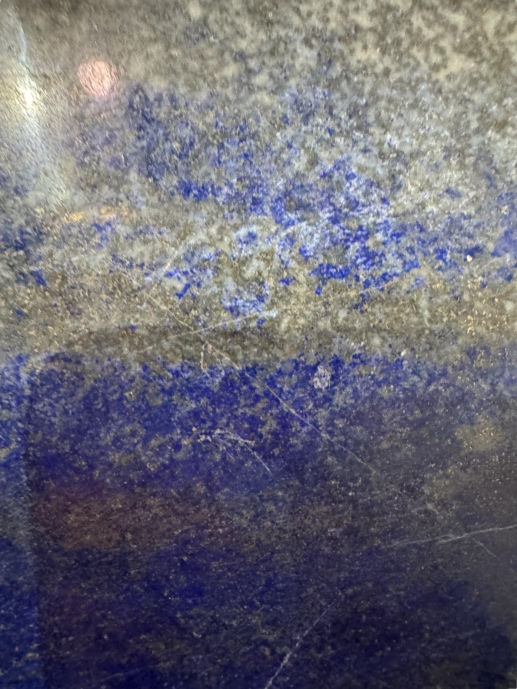 Hand-carved octagonal box made of lapis lazuli, featuring a red cabochon stone on its lid.