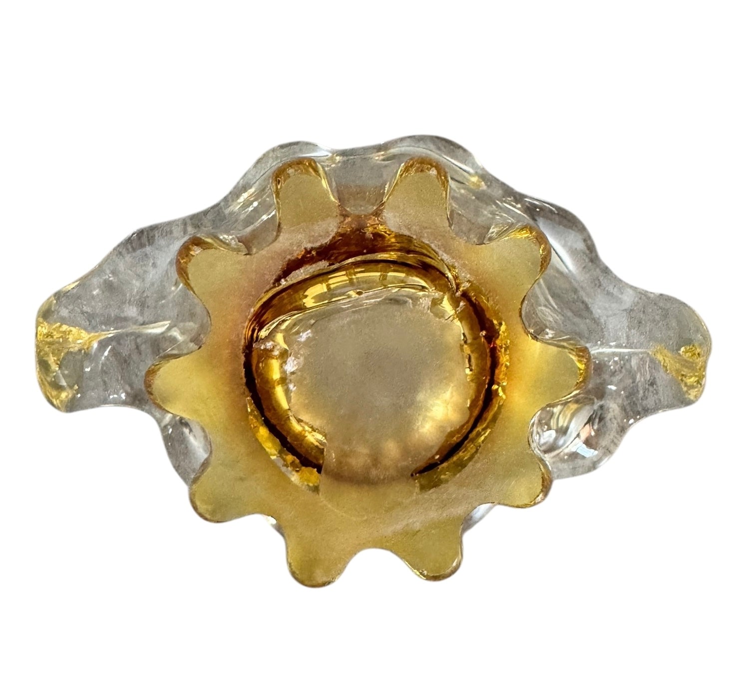 A hand-blown art glass vase with a scalloped, tulip-shaped rim, featuring an amber-to-clear color gradient and a ribbed base