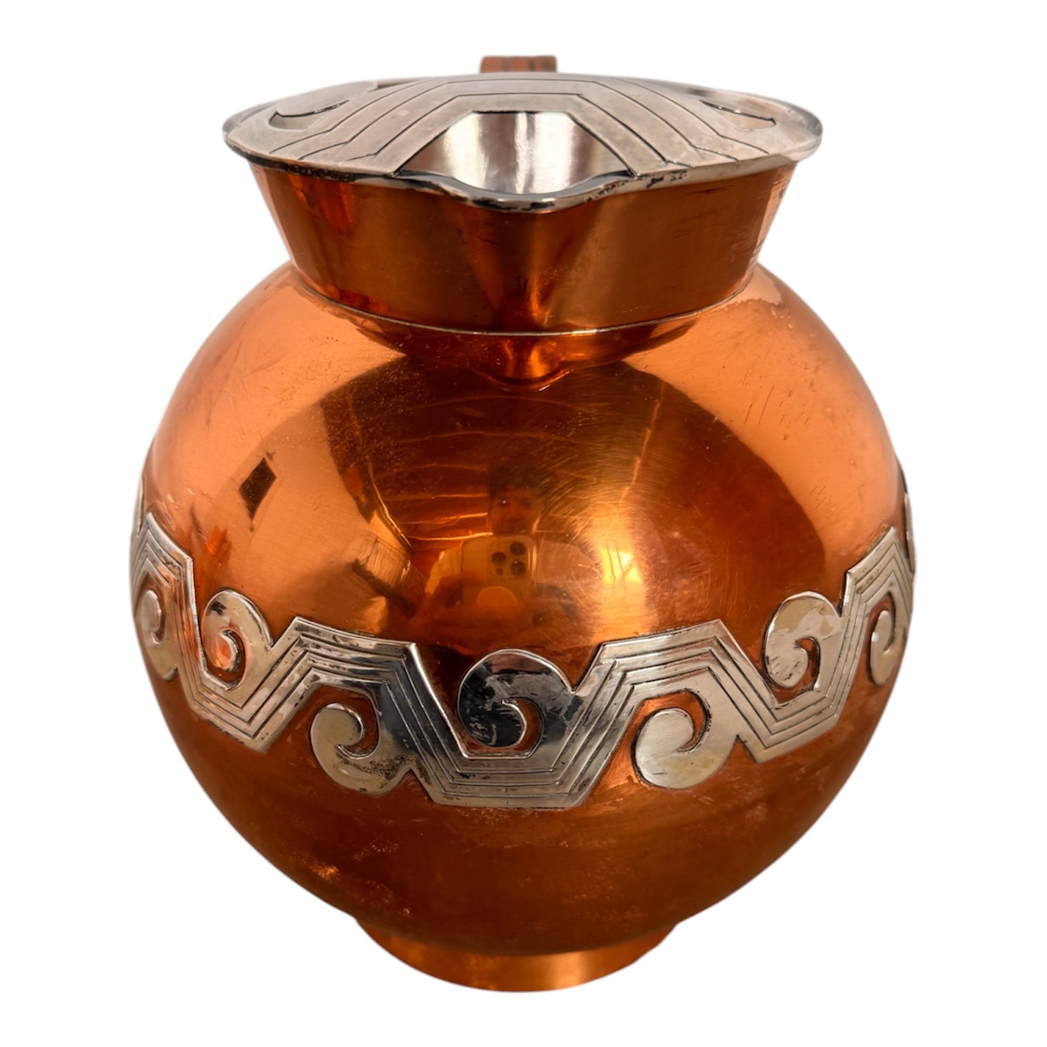 The set includes a large, rectangular, hammered copper tray with geometric openwork handles. Resting on the tray is a tall, slightly tapered copper coffee pot with a wooden handle, a matching smaller creamer pitcher with a similar wooden handle, a lidded sugar bowl, and a tiny matching metal cup or jigger. To the right off the tray sits a large, spherical copper water pitcher or jug with a wide mouth and ice lip.