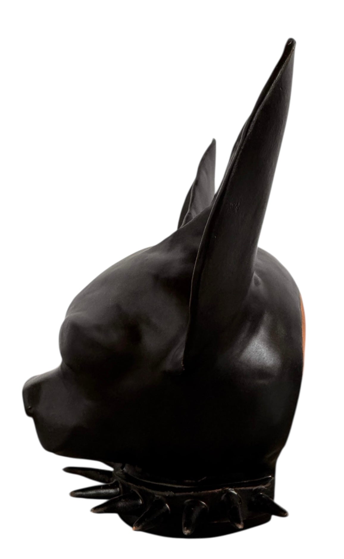A smooth, dark black-colored ceramic sculpture of a Miniature Pinscher's head. The stylized dog features large, upright pointed ears and a prominent spiked collar around its neck. The surface has a soft sheen, with minimalist indentations for eyes and a rounded snout, creating a sleek and modern aesthetic.