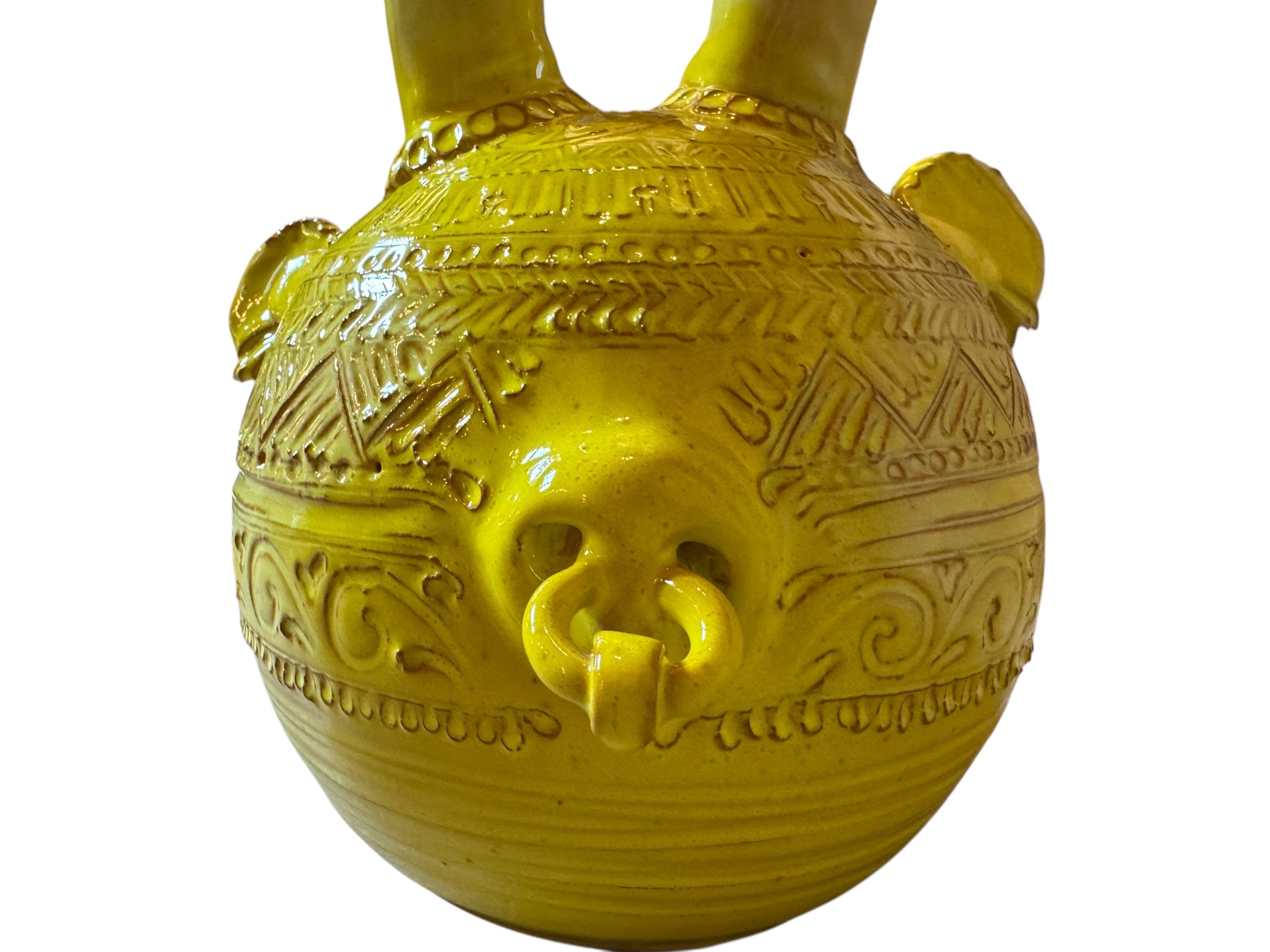 Yellow ceramic sculpture titled 'The Ram Oracle' by Enza Fasano, featuring a round body with intricate, hand-incised patterns and long, stylized ram-like horns