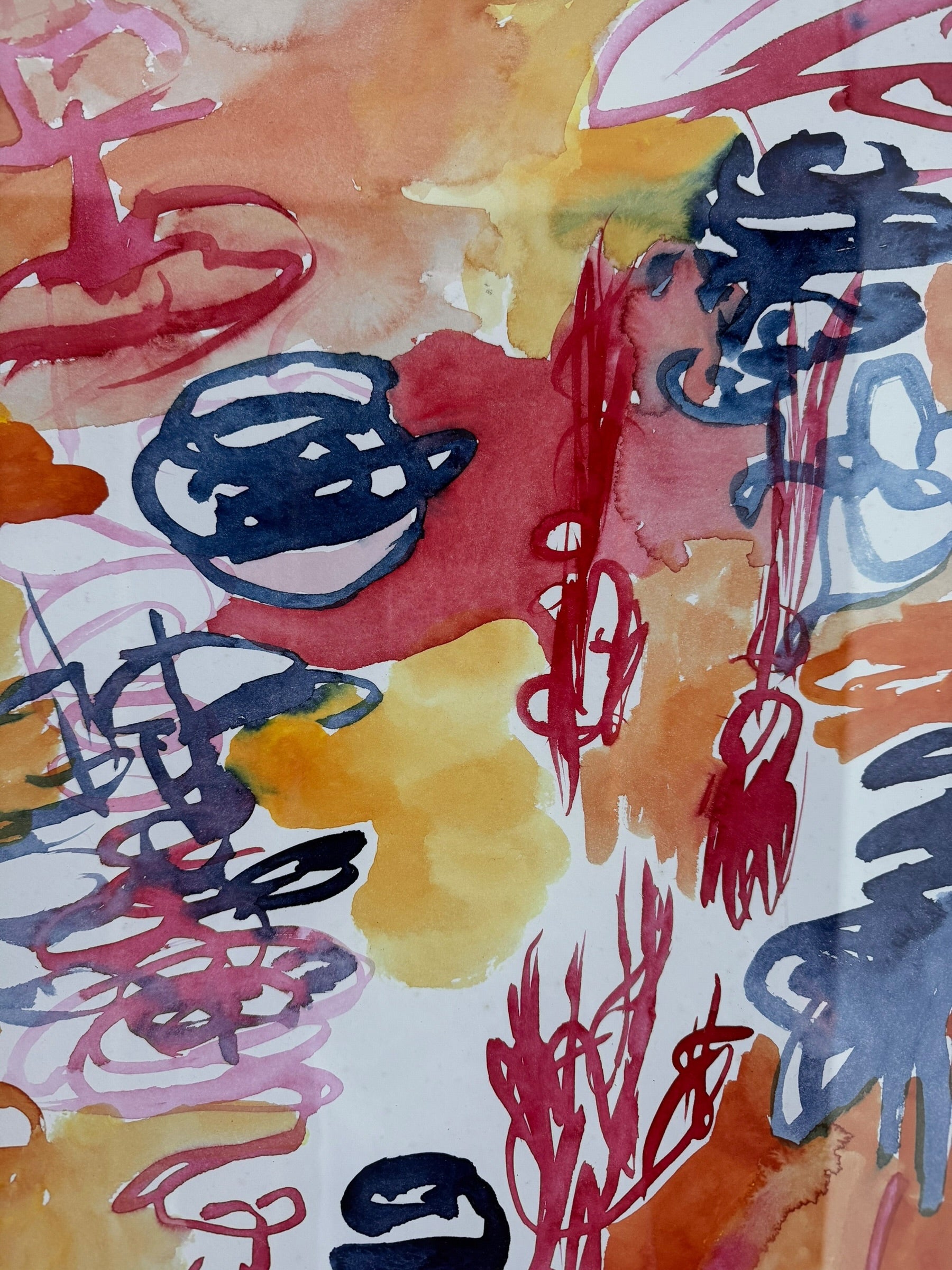 A vertical watercolor painting on paper, framed in a simple dark wood frame. The piece consists of a lively arrangement of gestural, loopy shapes and washes in a warm palette of apricot, magenta, and deep navy blue. The shapes are layered and translucent, with some areas featuring saturated "blooms" of color and others showing thin, wiry line work. The artist's signature and the year '97 are visible in the bottom right corner.